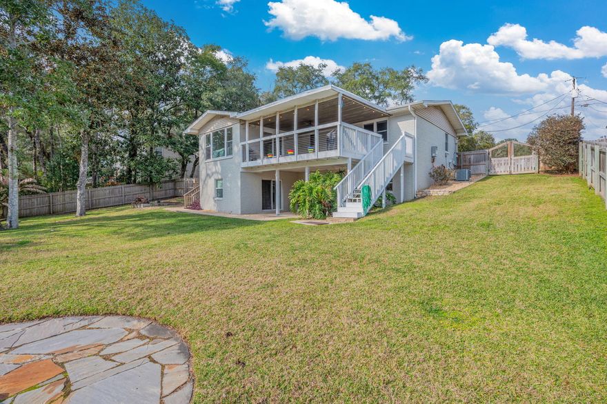 Gracefully set on .37-acre lot, this exceptional brick residence offers unique opportunities with expansive living spaces across two levels. MIL quarters? Teen suite? This home may be the answer for you. Upon entry, the foyer introduces a thoughtfully designed layout. To the left, a well appointed mudroom provides everyday functionality plus storage closet and second pantry. To the right, the kitchen is both timeless and sophisticated, featuring crisp white cabinetry, granite countertops, tile backsplash, stainless steel appliances, gas stove, and sleek recessed lighting. Convenient access to attached garage enhances ease of daily living.The main level unveils an open living & dining area flooded with natural light. Newer windows and sliding glass doors create an airy and inviting atmosphere. Sliding doors open to an impressive 350 sqft covered balcony with tongue and groove pine ceiling. Enjoy overlooking the tranquil backyard offering the perfect setting for quiet moments of relaxation and entertaining.

Lower Level provides remarkable versatility, featuring an expansive flex space with a kitchenette and breakfast bar overlooking the lush backyard.  This level is ideal for entertaining, extended living, game room, private guest accommodations or your own primary suite. Two sets of sliding glass doors giving direct access to a covered patio, further enhancing the home's seamless indoor outdoor connection.

Some additional features include;  tankless gas water heater, new roof in 2021, oversized garage with high ceiling, and an abundant amount of parking opportunities for all types of vehicles. This home has been loved while meticulously maintained and cared for as highlighted on Sellers feature sheet. 

A rare opportunity for qualified VA buyers to assume an existing VA loan with an approx balance of $370,000 at an outstanding 2.75% interest rate. This unique offering, combined with cozy design, generous living spaces, and picturesque setting, makes it a truly remarkable find.