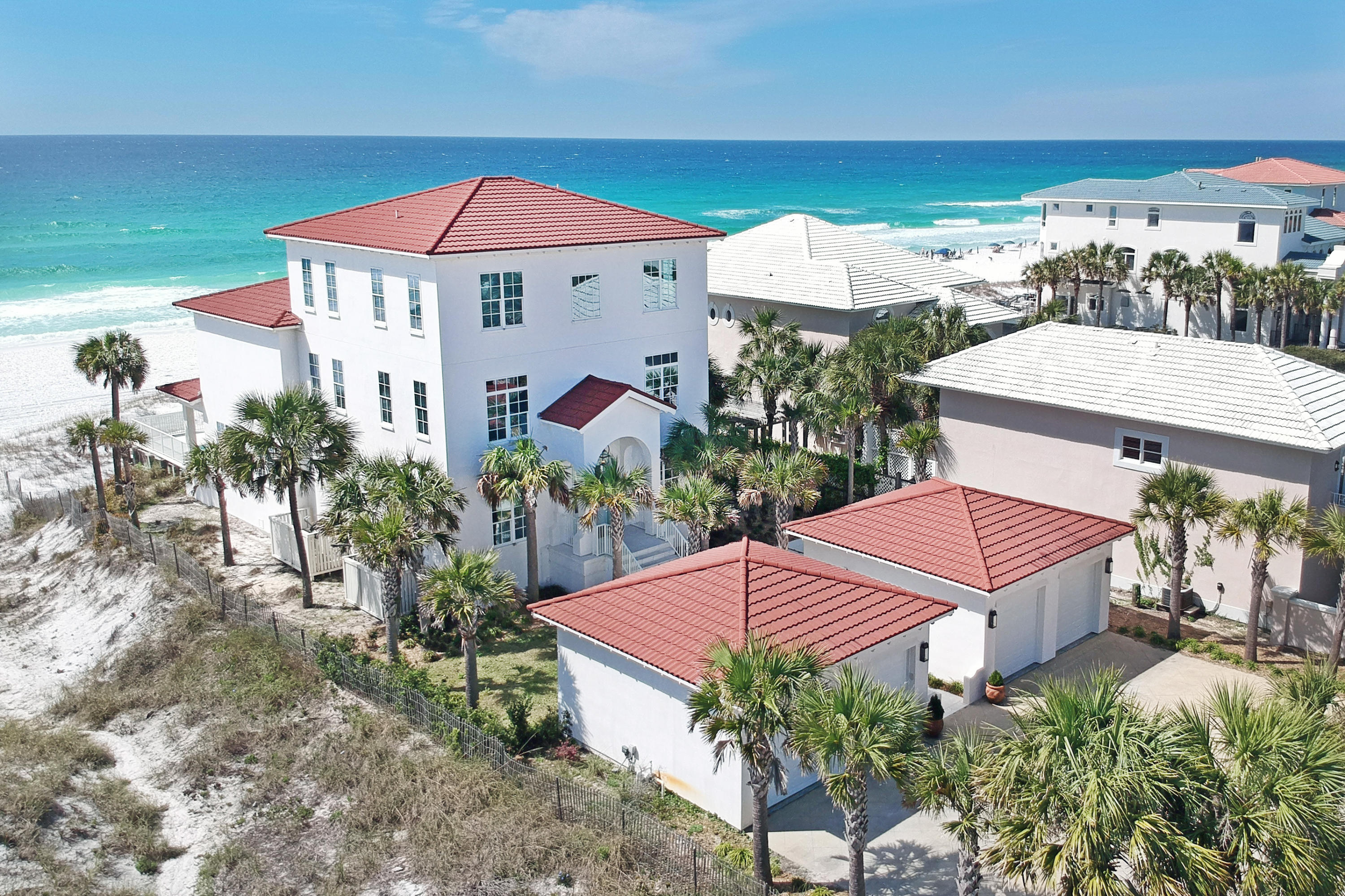 This luxurious beach front home sits on almost 1/2 an acre of land, with 4 large garage spaces and ample driveway parking for guests. Peacock pavers guide you through the walkway up to the entrance. The home is finished with coastal chic decor & expansive main floor features a foyer with elevator, storage, guest bath, dining areas, two living areas, pass-through fireplace and all with panoramic views of the Gulf of Mexico. White sandy beaches are directly off the Gulf-side pool deck, shower & covered patio. There is a spacious gourmet kitchen, large center island & bar seating, equipped with stainless steel appliances, granite counters, double ovens, ice maker, and a gas-range. The laundry room is off the kitchen with washer, dryer, utlilty sink and pantry area with a second refrigerator.