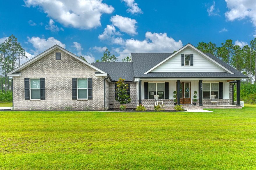 This is 'THE ONE!!' Major PRICE IMPROVEMENT! Quality craftsmanship is apparent in this exquisite modern farmhouse style home situated on 7 acres in north Baker. The setting for the home is a private one being situated off the road a bit down a meandering driveway w/ a wood line buffer on all sides and backing up to Gum Creek Lodge. Experience all that the modern farmhouse style living has to offer in this beautifully crafted home starting w/ the large front porch featuring tongue in groove ceilings and double front entry doors. Inside you will find the popular open floor plan concept and a cathedral ceiling w/ stunning wooden beams  along w/ luxury vinyl plank flooring and 8' doors throughout. Spacious living room features a striking shiplap accent wall w/ electric fireplace. Bright and sunny kitchen boasts beautiful white cabinetry quartz countertops, a stunning blue glass backsplash, under cabinet lighting and pantry w/ nice wooden shelving. Off the kitchen is a built in bench for shoes, backpacks, etc perfect for unloading when entering through the garage. Master suite is spacious and has dual vanity, classy black and white tiled shower and large walk-in closet that also leads into the laundry room. Great design!! Nice sized guest bedrooms w/ a Jack-n-Jill style bathroom in between. Bathroom vanities are oversized and also feature the quartz countertops. A half bath for guests is located just off of the living room. Oversized rear covered porch also has the beautiful tongue in groove ceiling. A Generac whole house generator will give you peace of mind should power be lost. Other great features of this property are an oversized garage door to fit those large vehicles, a private well and irrigation system. A true gem in the heart of Baker!! Buyer to verify all areas of importance for themselves. 