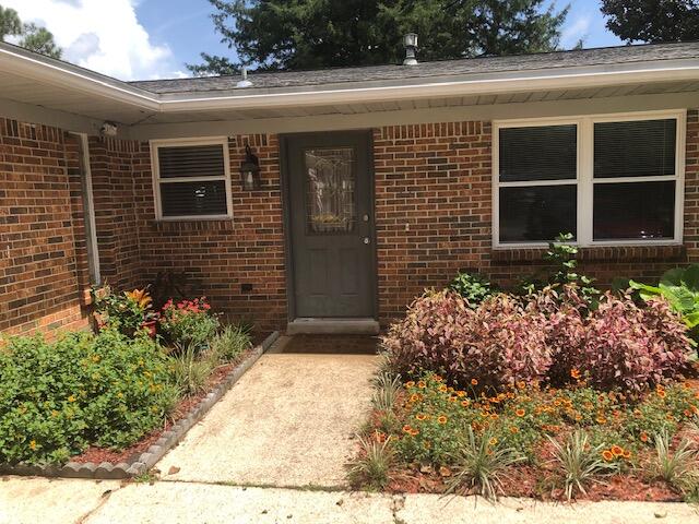 Located in the subdivision of Kenwood, in the heart of Ft. Walton Beach. This charming and updated four bedroom home features new LVP floors in the Living room and down the hall. Tile floors in the large eat in kitchen and upgraded master bath. Open floor plan, upgrades on all the ceiling fans and built in book case in the Living Room. The amazing kitchen offers a oversized island, perfect for food prep. Gas appliances and all wood cabinets. This home has a wet bar area complete with sink and small fridge and open shelves. The sunny eat in area has sliding glass doors that leads to a pergola covered patio with a swing. Master bedroom has a sweet window seat, just made for an afternoon of reading. Master bath has new tile and and glass doors. Vintage Hall Bath has original tiles and double sinks. 3 bedrooms with ceiling fans and carpet are located in their own wing. Back patio is shaded by beautiful Trees and offers a fenced in yard.