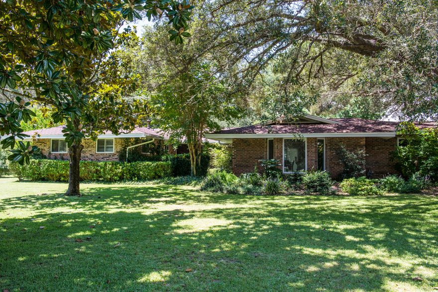 Classic Lake Lorraine home sits on a beautiful corner lot with mature oaks and magnolias. This home is 2549 square feet offering an open floor plan with a large kitchen with granite counters, custom cabinets and built-ins and 2 large living areas. There are 4 bedrooms total with one large master bedroom and remodeled bathroom. The other 2 bedrooms on the west side of home share a bath. On the east side of the home, you will find an additional bedroom, powder room and laundry room with the hall leading out to the large 2 car garage. The home was remodeled in 2007 and was mostly taken to the studs with new sheetrock, cabinets, windows, and sliding doors. The roof is 2 years old along with a Rheem tankless hot water heater. The yard is huge. Plenty of room for a pool or outbuilding.