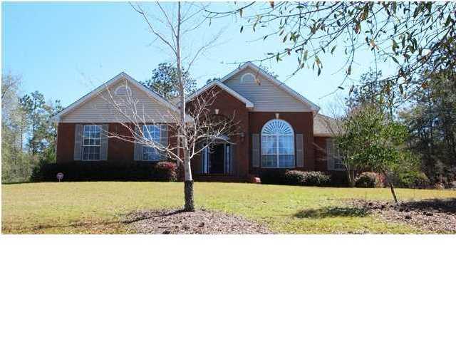Where to begin?? First of all there is the large one acre lot that is the majestic setting. Add to that the custom, all brick construction and architectural shingle roof. Sweeping driveway up from the road leads to the two-car, side-load garage. Lovely landscaping accents the exterior. And, as to the interior.....WOW!!! The home features high ceilings (twelve feet in the foyer, great room, and bedroom 2. Nine feet in other rooms), dramatic double trayed ceilings in the dining room and master bedroom. The master bedroom has a separate sitting room with a ten foot trayed ceiling and built-in bookcases. The master bath boasts a garden tub, separate shower, and very large walk-in closet. The secondary bedrooms are large and bedroom 2 has a circle top arched window for lots of light.