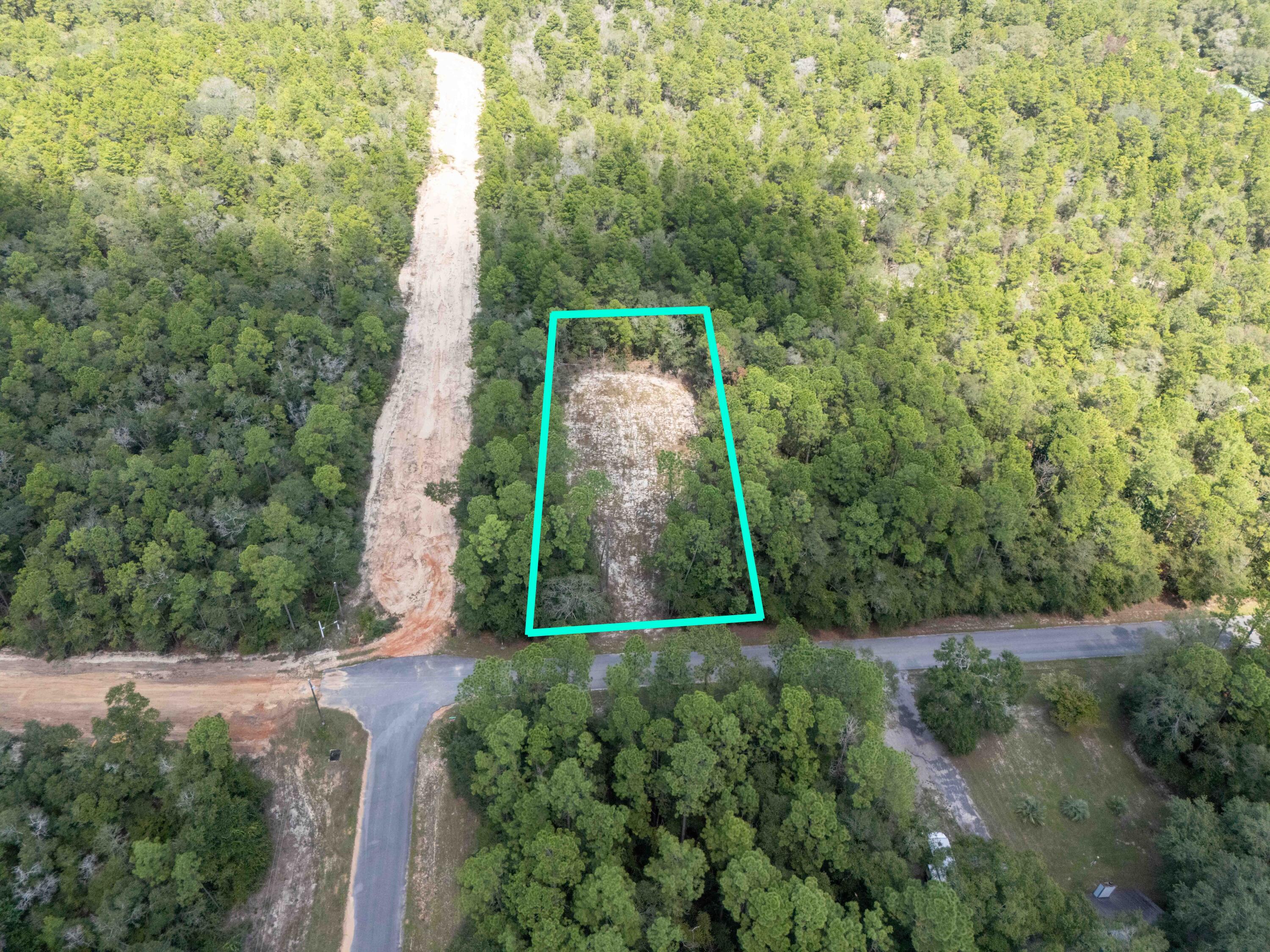 Exceptional building lot, partially cleared and primed for your new construction. Wildwood Lakes features spacious lots, primarily over 1 acre, providing ample distance between homes and the privacy you desire. Conveniently located just 5 miles west of DeFuniak Springs, you can easily access Niceville, Eglin, or Crestview via scenic back roads. The neighborhood boasts a rural atmosphere due to the generous lot sizes. There's no HOA, and manufactured or mobile homes are prohibited. A well and septic system will be necessary, with electricity readily available at the road for connection. The clearing has already been done, saving you thousands, and the level terrain will further reduce your construction costs. Visit your future homesite today!