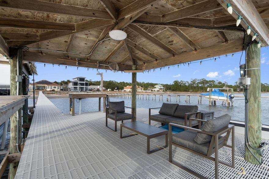 Beautiful waterfront home on Santa Rosa Sound. When you walk in through the glass front doors, the first thing you see is the breath-taking view that looks directly out to the water.  Open & bright, with oversize windows throughout the entire home, the rear windows are Pella Hurricane Windows. The gourmet kitchen was remodeled in 2023 with top-of-the line appliances to include double ovens, an induction cooktop and a Wolf Steam Oven and Built-In Coffee System.  Beautiful Quartzite Countertops and tons of cabinet space make this an absolute dream kitchen.  Head out to the back patio, where you will find the in-ground, gunite pool and large back yard, with a paver brick path leading down to another open patio area.  From there, you can head out to the impressive tiki hut boat dock, with flow through decking, a granite fishing station and two boat docks.  The Master Suite has a bay window sitting area, his & her closets, double vanities, a soaking tub and a separate shower, it also walks out to the pool area.  There are 3 additional large bedrooms, one is currently being used as an office.  Shaw Floorte waterproof LVP flooring through most of the home except 2 of the bedrooms have carpet and the master bath has tile floors.  There is a Formal Dining room and two separate living areas, perfect for entertaining guests.  This home also has an oversized 2 car garage with additional space for golf cart parking, a Generac Whole Home Generator, tankless water heater and Solar Panels that were installed in 2019.  Beautiful front yard landscaping with a paver brick driveway and  paths up to the front door and around to the back yard.  Just minutes from the white sandy beaches and emerald green waters of the Gulf of Mexico.  There are so many special features about this home, it is definitely a must see!!