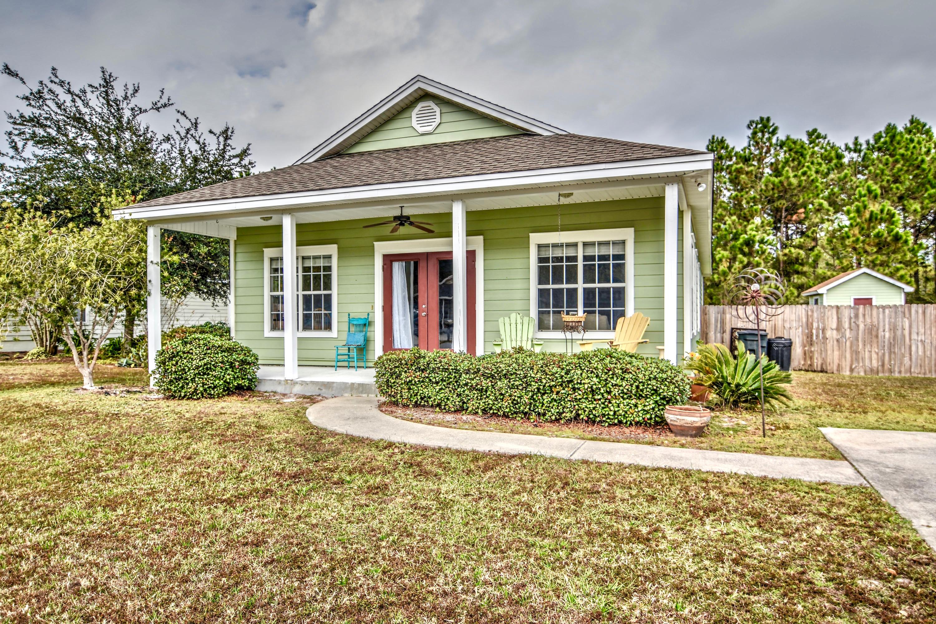 Perfectly Located close to the intersection of Hwy 98 and 30A. This very well maintained and cared for 3 bed 2 bath is located in the intimate community of Bayou Farms. This Florida Cottage with a freshly painted exterior carries engineered hardwood floors throughout and tile in the wet areas. The kitchen, which opens to the dining and living area, has stainless steel appliances with a propane gas stove and fresh paint. There is a separate laundry room off of the kitchen with a backdoor to the large fenced in back yard. The home has a large front and back porch, ample parking and a storage shed with loft space.