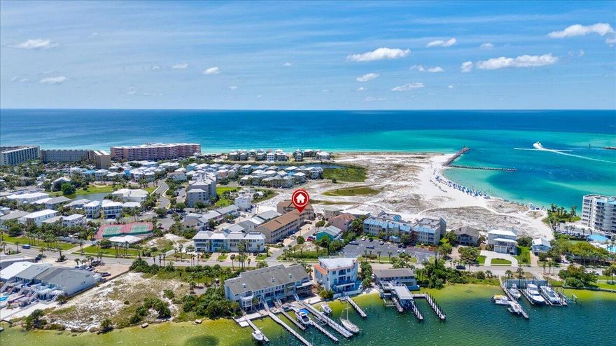 Located on the beautiful Holiday Isle, this end unit, 2 bedroom, 2 bath condo is perfect for your permanent residence, second home, or investment property. Recent renovations include fresh paint, luxury vinyl floors, granite countertops, and new lighting fixtures. What's even more impressive . . . a private parking garage! With enough room for two cars in tandem, you or your guests will have space for vehicles or golf carts. Coming off the balcony and through the front door, you'll notice the spaciousness of the great room. The clean white and open shelving in the kitchen and the natural lighting in the living room make the area feel comfortable and open. In addition to plenty of counter space for food prep and cooking, the kitchen offers a dining table for 4 and your very own coffee bar. An oversized sectional and accent chairs provide plenty of seating in the living area and allow everyone to enjoy their time together.
 Just down the hall, the primary bedroom and ensuite bath is beachy chic with warm wood accents and soft colors, giving an overall feeling of calm. The second bedroom is great for adults or kids with a bunk set up that sleeps three between the twin mattress on top and queen underneath. The second bathroom is adjacent to this bedroom and easily accessible for anyone staying in this gorgeous condo.
Ready to enjoy all that Destin has to offer? Noriega Point and the Destin Jetty East Beaches are just a few yards away, and the Noriega Point water taxi provides easy access to the music, restaurants, shopping, and water sports of Destin Harbor.
Because the property allows both short and long-term rentals, this condominium is an excellent investment opportunity, and it won't be on the market for long. You'll be doing yourself a favor to find out how this Gulf Winds unit can be yours!

