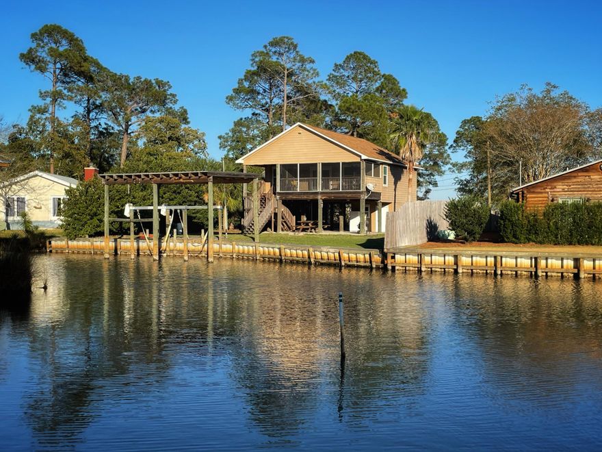 This peaceful, waterfront home sits on a large lot that is tucked away and boasts over 80 feet on a deep water canal and bayou with direct access to Choctawhatchee Bay.  Featuring 2 bedrooms and 2 baths, this home also offers a comfortable open layout, granite countertops and stainless steel appliances.  This elevated home sits on massive pilings that are roughly 16' wide.  Enjoy your morning coffee on the oversized screened in deck overlooking your backyard, 10,000 lb covered boat lift and the serene bayou/canal.  There's a large storage/work area downstairs that can easily be a fisherman's man cave and the whole family can enjoy Boating, Fishing, Paddleboarding and more in their backyard!  Take a look at this one, it's the perfect getaway home!  Buyer to verify all measurements.