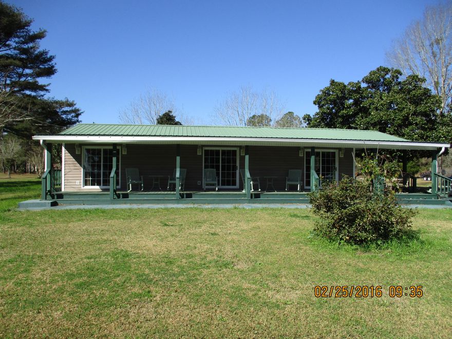 If looking for country charm, this is your next home. Totally customized home on six large lots with detached three car garage/workshop. This unique home offers solid wood floors throughout, crown molding, custom cabinets, cultured marble countertops, formal dining, large master bedroom with ample room for sitting area, and large family room featuring tons of natural light. Master bath features double vanities, dressing area, Jacuzzi tub walk-in shower. and separate outside entry. Convenient utility area off of master suite with additional walk in storage. Home features covered porches and large patio off of family room for entertaining guests. Priced to sell.