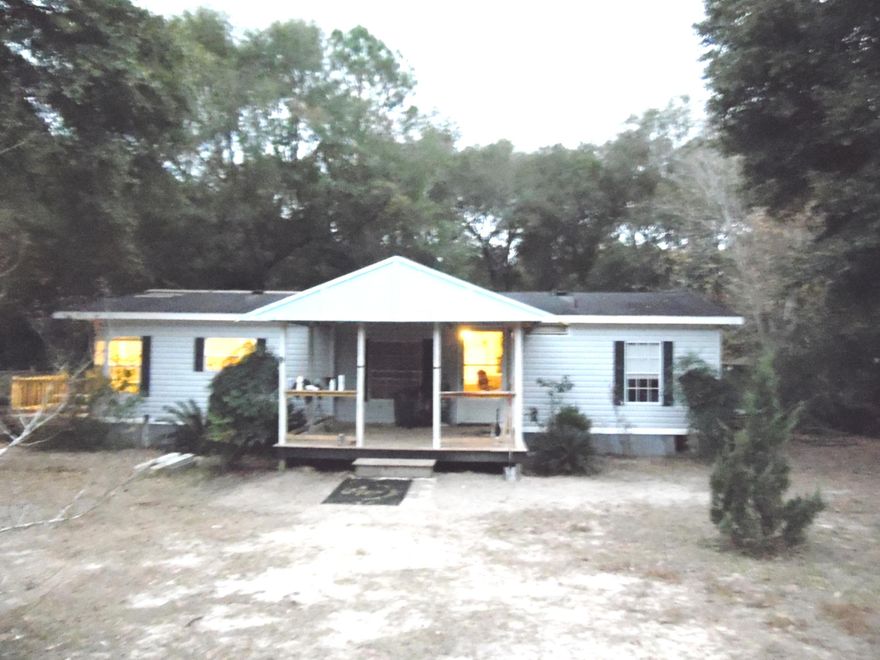 Locate near some of the best fishing in North Walton County. You are within a 1/2 of a mile of public launch for Lake Juniper. Enjoy living in this 1994 ''Grand Manor'' manufactured home 1292 square foot home with 3 bedrooms and 2 baths. Surrounded by large shade trees. Would make a great ''home-base'' for those with a travel trailer that needs a place to call home! Spacious living room and formal dining area. Kitchen features eat-in area, lots of cabinets and counter space, large pantry, with adjoining laundry area. Master bedroom with walk-in closet. Master bath has large garden tub with separate shower. Large covered front porch with new decking, new hot water heater, 2 new window a/c. Back yard features pole barn/storage area and fenced on three sides. City water & septic.
