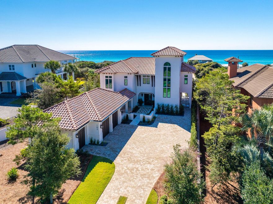 Completed in late 2022, this beautifully crafted coastal home is set within BellaMar, an exclusive gated enclave with only seven homes along the 30A corridor. Built by Grand Bay Construction in collaboration with architect Jeff Margaretten and landscape designer Chad Horton, this elevated 0.41-acre property in Flood Zone X captures the essence of refined coastal living, maximizing natural light and Gulf views from the second and third levels.A courtyard with a fountain creates a serene sense of arrival, leading to custom entry steps and a layered facade that reflect coastal sophistication. Outdoor living shines with a heated and chilled saltwater pool, while inside, white-oak finishes and soft coastal textures create an effortless flow throughout this 3,916-square-foot home. The living room exudes sophistication with coffered ceilings, while the primary suite adds warmth with exposed white-oak beams. The kitchen is a chef's dream with Sub-Zero, Wolf, and Cove appliances. Additional features include a three-stop elevator, service lift, temperature-controlled garage, and Sonos audio system with three zones. The third-level flex space, finished in Venetian plaster, opens to a sunset deck where Gulf views stretch toward Sandestin Golf & Beach Resort - a breathtaking backdrop for evening gatherings. This level also offers potential for a wet bar or bath, with access to waterlines in the walk-through attic.

BellaMar is a private, short-term-rental-restricted community bordered by the Santa Rosa Golf & Beach Club, offering spacious homesites, deeded beach access, and sidewalks to Gulf Place Town Center - an ideal blend of tranquility and connection along 30A's west end. Nearby, Santa Rosa Beach offers miles of shoreline, boutique shops, and coastal dining, with state parks, boating, and paddleboarding all close at hand. Experience coastal living at its finest at 102 Sea Winds Drive - where style, comfort, and luxury meet in perfect harmony.