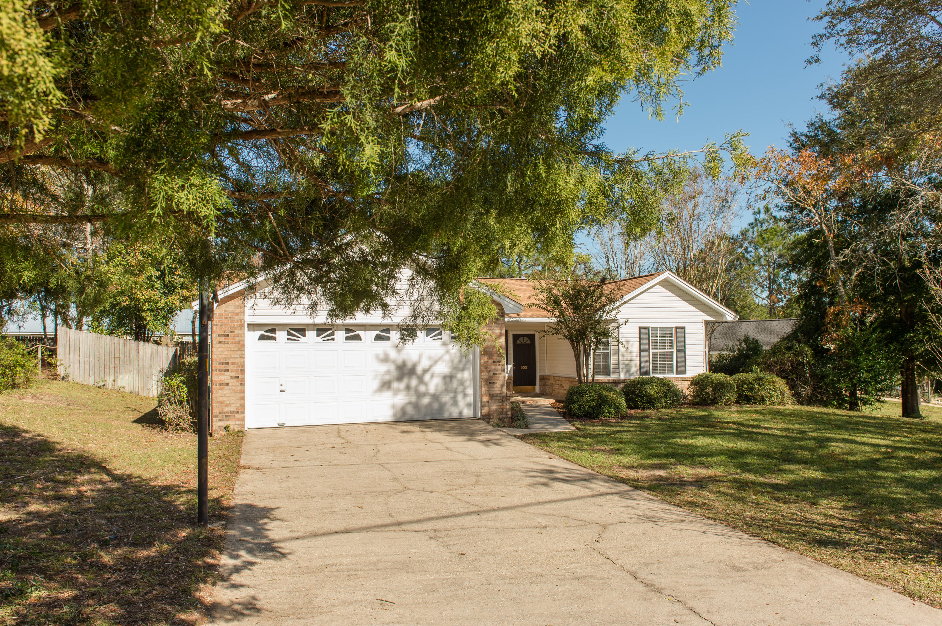 Must See - Incredible find in desirable south Crestview. This is an affordable and well maintained 3-bedroom, 2-bath home nestled on an attractive 0.27 acre corner lot. This home has a brand new 30-year architectural shingle roof, just installed carpet throughout, tiled kitchen with updated cabinetry and freshly painted interior. This charming home is move-in ready on a large landscaped corner lot overlooking a rolling hill vista with mature trees, private fenced backyard and a covered front porch area. There is plenty of parking and outdoor space along with an attached 2-car garage with storage.The 1,468 square foot open floor plan features bright and open living areas with vaulted ceilings. The living area opens up to the kitchen with tile floors and breakfast bar.