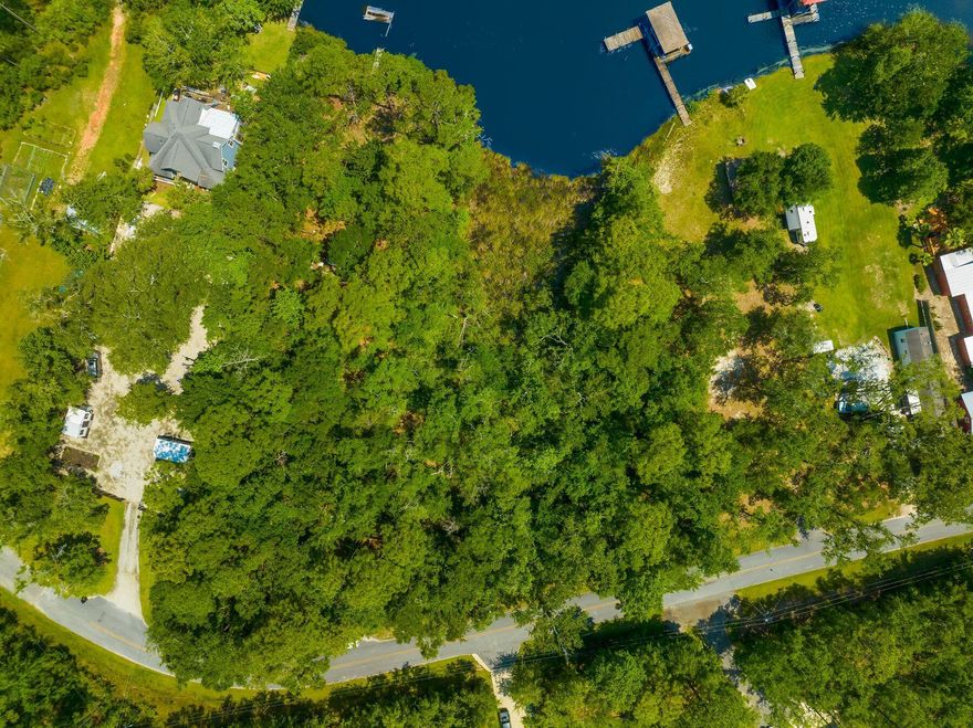 Nestled along the pristine shores of Freeport, this captivating bayfront lot beckons with the allure of a boater's paradise, offering an idyllic retreat amidst the tranquil waters of Choctawhatchee Bay. Situated on a secluded, no HOA street, this haven exudes exclusivity and serenity, promising privacy and seclusion of bayfront living without sacrificing convenience. Whether it's a waterfront estate with sweeping views of the bay, or crafting a cozy coastal retreat, the potential of this lot is as vast as the horizon stretching before it. For the individual seeking a harmonious blend of privacy, tranquility, and untapped potential, this bayfront lot in Freeport stands as a testament to the beauty of coastal living and the promise of a life well-lived amidst the timeless allure of the sea