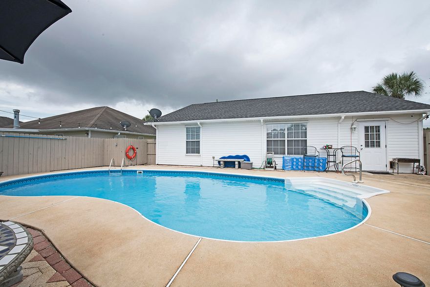 SPLASH TIME IN YOUR SALT WATER POOL! You will love this 3 bedroom 2 bath home with all of the upgrades! 2018 ROOF, HVAC & Gas Hot Water Heater! ENTERTAINMENT BONUS ROOM & COMPLETELY USABLE GARAGE: See it to believe it. Currently used as MAN CAVE! Completely Insulated Heated and Cooled w/Separate Mini Split AC Unit, Insulated Garage Door & Water Proof Flooring...the possibilities of this bonus feature are endless! Brand New Salt Water System and Lighting for the Pool, enjoy your paved patio & covered porch on any sunny day! Brand new Kitchen Appliances, updated porcelain tile throughout, Laminate flooring in bedrooms, brand new carpet over top of the tile in the living room as well. You will love the location and lot of this home!