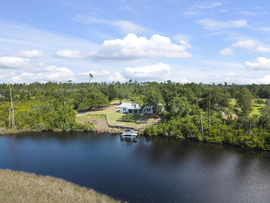 Rare opportunity to own a beautifully updated 3-bedroom, 2-bath brick home with Gulf access, situated on 5 private acres along Cook's Bayou. This property offers exceptional flexibility--bring the boat, RV, four-wheeler, or horse--with room to live, work, and play in a peaceful waterfront setting.Built in 1976 and thoughtfully renovated, the 1,855 sq ft home blends classic character with modern upgrades. Interior features include fresh paint, quartz countertops, new ceiling fans, and closet organizers throughout. The primary bathroom has been fully remodeled, and the kitchen is equipped with an induction cooktop, double ovens with convection and air-fryer modes, and stainless steel appliances--all less than three years old. Significant improvements include popcorn ceiling removal, 2024 HVAC, Honeywell programmable thermostat, Pristine Air UV filtration system, water softener, generator outlet, 2017 metal roof, hurricane ties for wind mitigation, and a whitewashed brick exterior.

Outdoor amenities include a solar-powered gated entrance, 12'x32' shed, motorized screened back porch, raised metal garden beds, citrus trees, private pond, and mature moss-draped oak trees. Nearly $30,000 in dock upgrades include an expanded dock and 7,000-lb boat lift, providing direct access to the Gulf.

Property sits on tidal waters with Gulf access through Cook's Bayou. Bridge vertical clearance is approximately 9'6", suitable for smaller boats. John Deere tractor and attachments convey with sale.

Ideal for a private waterfront homestead, recreational retreat, or future expansionthis unique property offers space, privacy, and true Florida waterfront living.