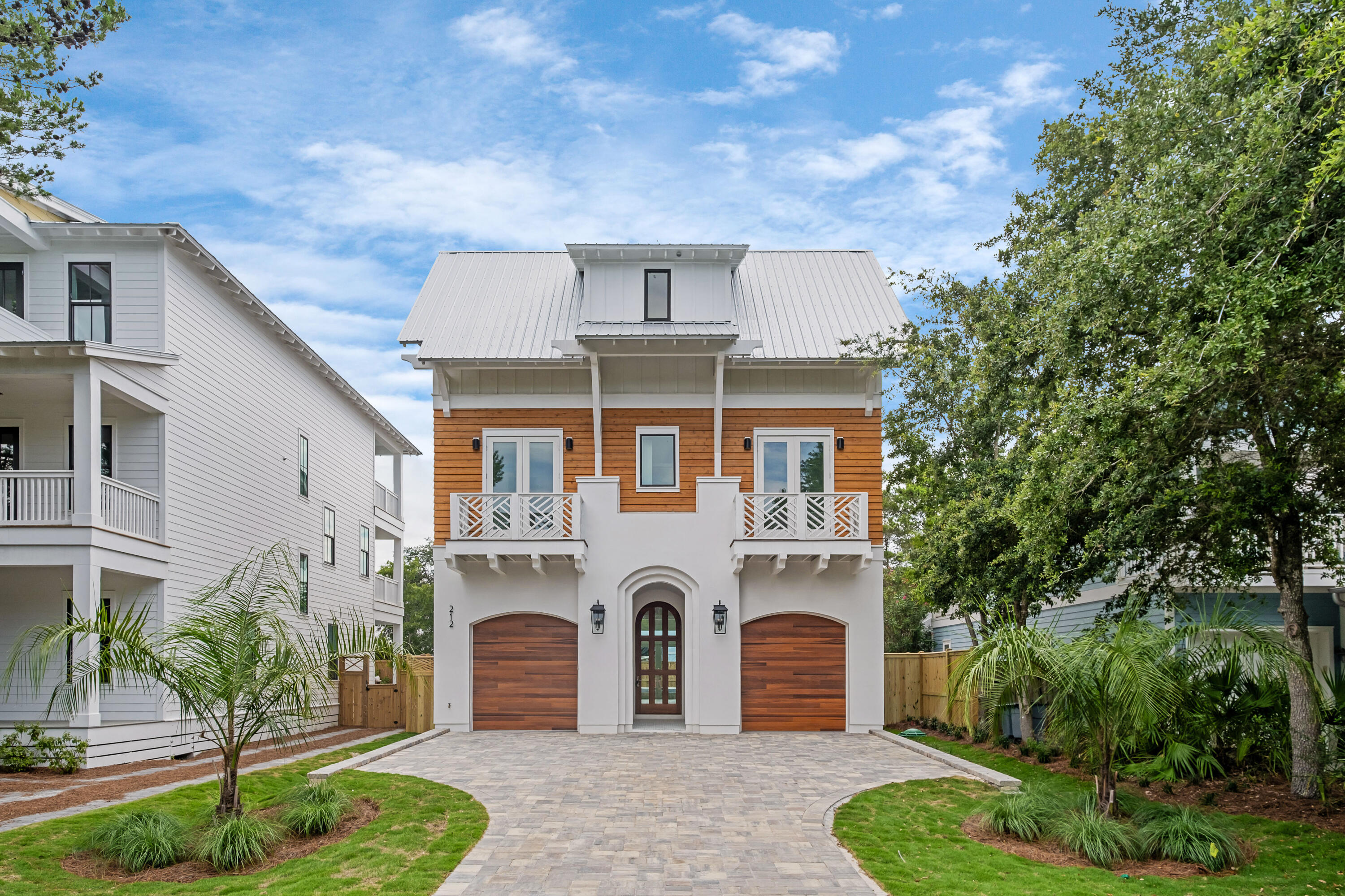 Stunning new construction home perfectly positioned in a prime Seagrove location within close proximity to large public beach access. Enjoy the spacious lot with a plethora of pavered parking, green space, large backyard with pool/hot tub combo, all with no HOA dues. This luxurious beach estate is the perfect combination of laid back living and upscale sophistication. The entry of the home greets you with a tiled front porch leading to the gorgeous arched mahogany front doors. The main level was designed for entertaining with its high ceilings and large open floor plan that includes the living room, kitchen, and dining area. Large doors blend this space seamlessly to the outdoor pool deck where you will find a very accommodating pool plus an integrated hot tub with waterfall feature. The living room space is adorned with a gas fireplace, wet bar with 2 wine/beverage refrigerators, shiplapped walls and white coffered 12' ceilings. The well appointed kitchen comes complete with a Thermador appliance package, beautiful tile backsplash wall that runs to the ceiling, marble counters with gold accents, and a hidden walk-in pantry! White oak flooring and shiplapped walls round off the coastal feel and run throughout the home. Perhaps one of the best features of the main level is 2 garages! You will also find a 1/2 bath and 3 stop elevator on the first floor for added convenience. The second floor has a large master suite with private porch, huge walk-in closet, and grand master bath. Adjacent to the stairs you will find a large flex space, offering a multitude of opportunities. This space also has a 1/2 bath beside it making it great for a bunk room conversion or living area. The east end of the second level contains 2 guest bedrooms, both with ensuite baths. There's also a very spacious laundry room on this level. The 3rd floor is a similar reflection of the 2nd. It consists of another primary suite with private porch. There's also additional laundry hookups in the primary closet. The flex space on this level is also filled with opportunity to transform into a bunk area, game room, office, or living room. The east end of this floor has 2 guest rooms and a shared bath. All closets throughout the home have wood built-ins. The home was constructed with extreme attention to detail and high-quality finishes, including Ipe wood decking. Enjoy prime Seagrove living with the Eastern Lake public beach access being just under 900 feet away where the county has assembled over 6 acres of beach. This beach access also allows for access to Eastern Lake and its outfall to the gulf, making it a very unique experience. Seagrove is centrally located along 30A with close proximity to Seaside, restaurants, shops, and all that the 30A has to offer. 