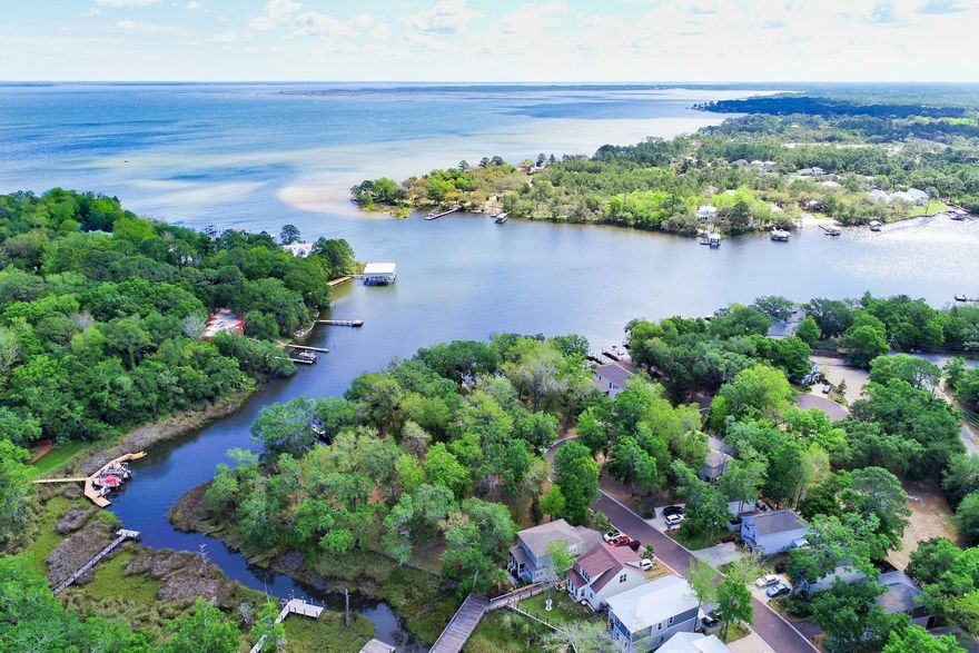 Boater's Dream location!! Sacred Oaks is an established waterfront community on Mack Bayou with easy access to the Choctawhatchee Bay and low HOA fees. Enjoy 105 feet of deep waterfront with the COVERED BOATHOUSE, DOCK AND TWO LIFTS (7500 LB capacity each). Build your dream home on this .429 acre high and dry parcel with electric and water on site and seawall. No buildout time. Additional lot on either side are available and combined would be -3/4 of an acre of amazing waterfront living. Sacred Oaks is conveniently located near Sacred Heart Hospital, Grand Boulevard, Publix and the beautiful beaches of South Walton and 30A. All measurements are approximate and buyer to verify.