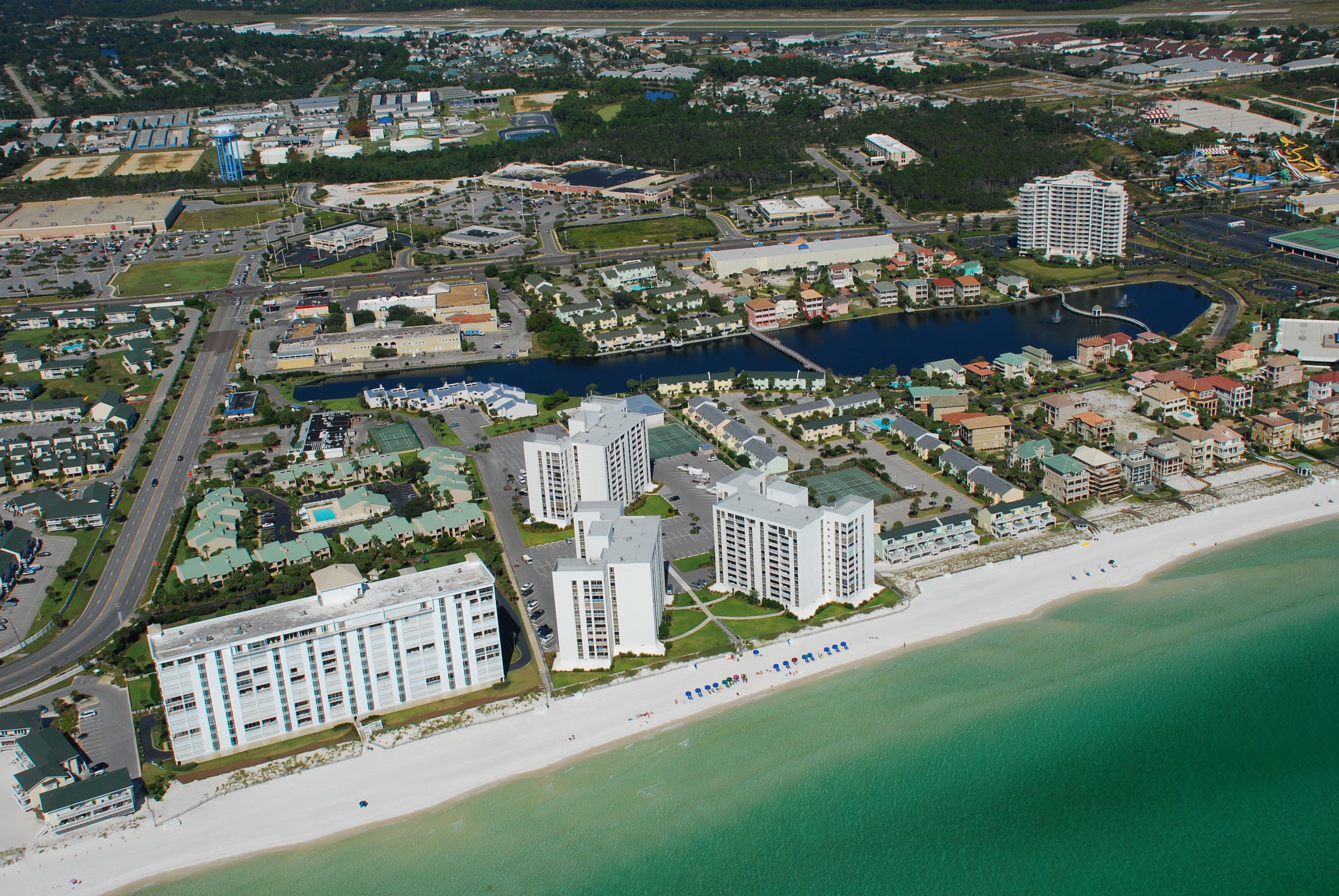 SPACIOUS, TASTEFULLY DECORATED 3 BR 2 BA END UNIT WITH UPDATED OPEN FLOOR PLAN OFFERS VIEWS OF THE GULF, HARBOR AND LAKE. WOULD MAKE A GREAT PRIMARY, SECOND RESIDENCE OR VACATION RENTAL UNIT. $30,000-$40000 RENTAL POTENTIAL. THIS CONDO CONVEYS FULLY FURNISHED AND INCLUDES A WASHER DRYER. SHORELINE TOWERS IS A GATED COMMUNITY WITH 24 HOUR PATROL AND ADDITIONALLY FEATURES SPACIOUS UPDATED CLUB ROOM W/KITCHEN, SAUNA, HEATED POOL, FITNESS CENTER, TWO LIGHTED TENNIS COURTS, SHUFFLEBOARD, PICNIC AREA WITH GAS AND CHARCOAL GRILLS, BOAT & TRAILER PARKING, FISHING LAKE AND HANDICAP BEACH ACCESS WITH 460'' OF PRIVATE WHITE SAND BEACH. WALKWAY STORAGE UNIT AVAILABLE FOR $500 FEE, NO PETS ALLOWED.