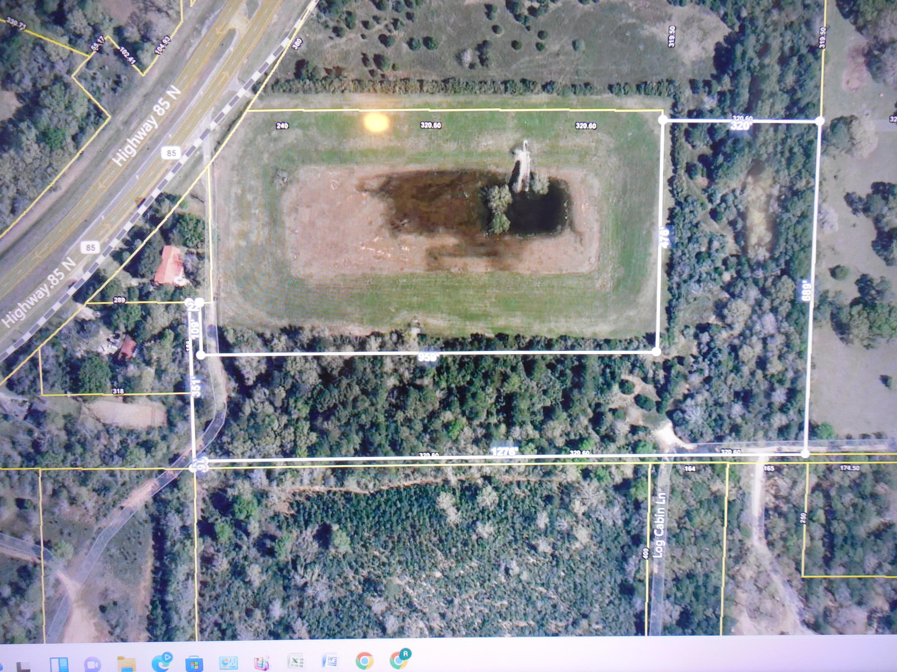 Great location for a potential business and/or residential development just off Hwy 85 N approximately 1.7 miles north of the intersection of Hwy 85 and Airport Road. This parcel is 10.12 acres in size and is mostly wooded with large trees. Currently, the front 5 acres of this property closest to Hwy 85 is zoned for mixed use and the back of this property which is approximately 5 acres is zoned R-1 residential. The possibilities for use are numerous and could include development of a large homestead, several large residential lots or development of a small subdivision with possibly up to 15-20 smaller lots and/or light commercial development. It is possible that the dual zoning for this lot can be rezoned to either R-1 or mixed use for the complete lot depending on the buyer's intended use. Buyer would have to do their due diligence and submit application to the county for requested zoning change. Available utilities include electricity front and rear and city water at the rear of the property. Possible uses for this property include a large private homestead, development of several smaller residential lots, RV park or storage, light commercial development or a combination of residential and commercial development.