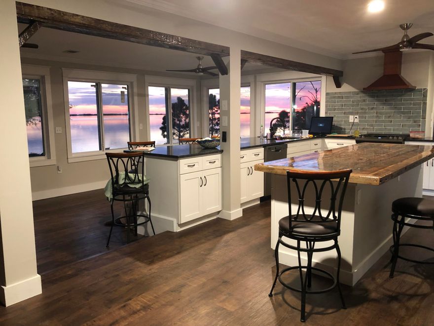 Walk in the front door and enjoy the open floor plan and panoramic view of the Santa Rosa Sound! Lay back in the freestanding bath in the Master Bedroom and watch the sensational sunsets that are million dollar views. Everything has been updated over the last 2 years. This 3 master bedroom home has a massive new kitchen including a custom made peccy cypress island countertop, faux peccy cypress beams and fireplace mantle, copper hood, antique French oak luxury vinyl plank flooring throughout the house, new windows (with hurricane shutters) and 2 new AC units. Newly landscaped yard has brand new irrigation,  drainage system, a new fence and a raised seawall. The huge back patio has been updated with decorative concrete.