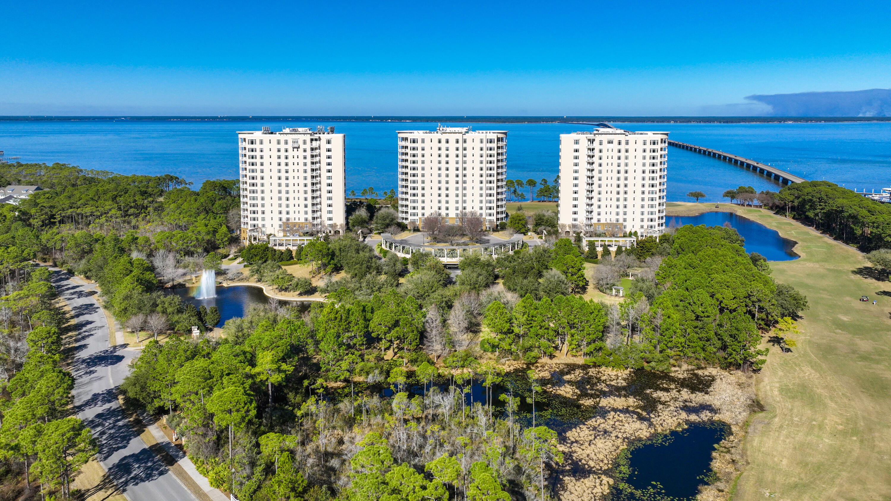 Located within Kelly Plantation, this condominium is in the east building of One Water Place. Views from this 10th floor condo are breathtaking, with panoramic views of Choctawhatchee Bay, the Kelly Plantation Golf Course, and the Mid-bay Bridge. The floor plan is the Darlington, characterized by its three terraces, spacious inside rooms, and three walls of windows in the master suite. The focal point of the residence is the beautiful living space with a gas fireplace and beautiful views of the Bay. Step out onto the spacious terrace and enjoy the views or prepare a dinner and entertain. The gourmet kitchen has upgraded appliances, granite counters, a breakfast bar and nook, center island, and custom integrated refrigerator. The dining room sits adjacent to the kitchen and features