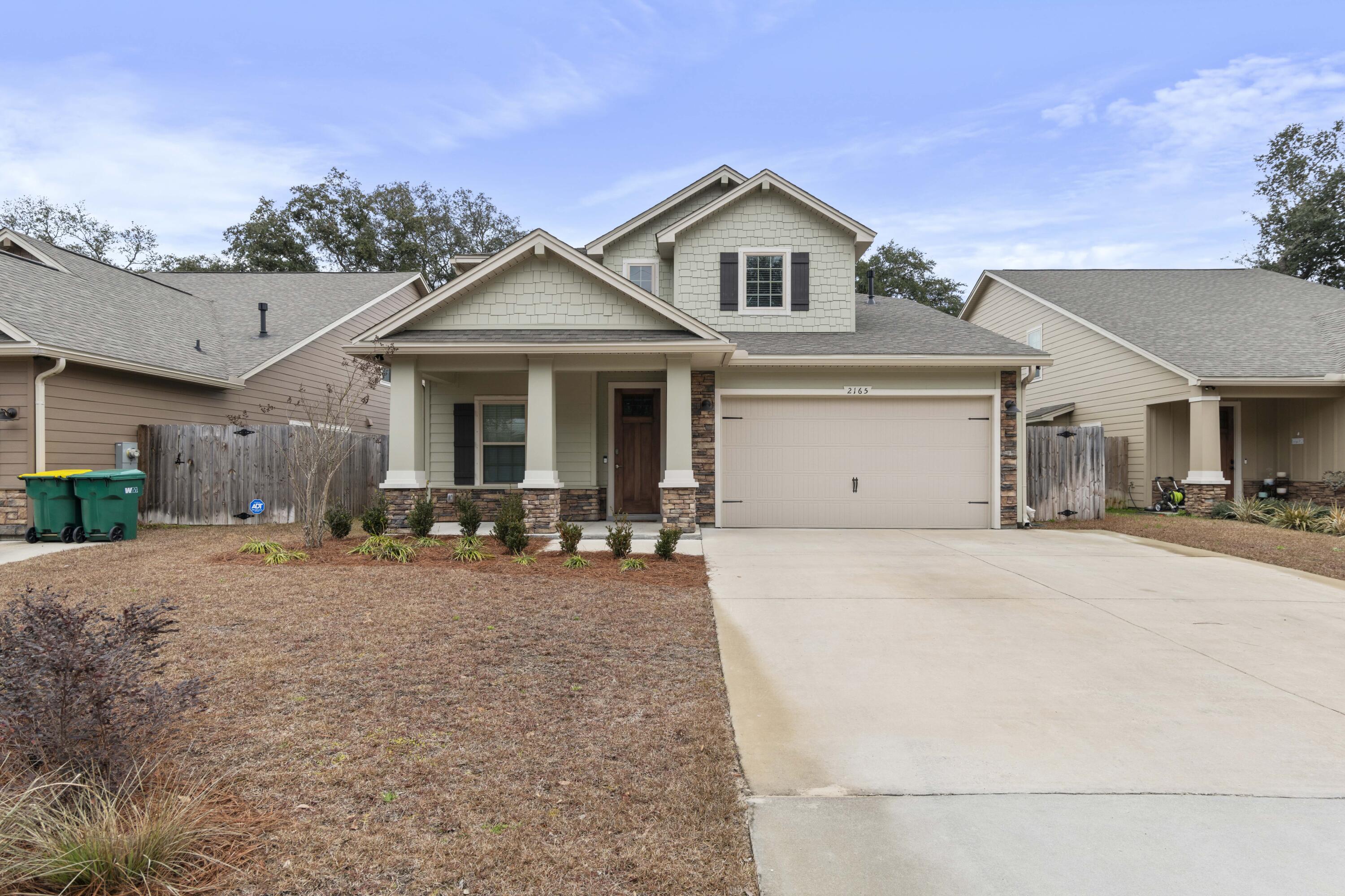 Located just 1/2 mile from the water, this stunning home offers charm, functionality, and outdoor living at its finest. The welcoming foyer opens to a versatile flex room, perfect as an office, den, or extra bedroom. The kitchen is designed for entertaining, with a breakfast bar, pantry, and open views of the cafe area and family room. The spacious downstairs master suite features dual vanities, a walk-in closet, separate shower, and a luxurious free-standing tub. French doors lead to a covered lanai and a backyard oasis with a paved fireplace and screened-in porch, ideal for relaxation or hosting guests. Plus, the home is under 2 years old, with all builder warranties still active. Don't miss this incredible opportunity!