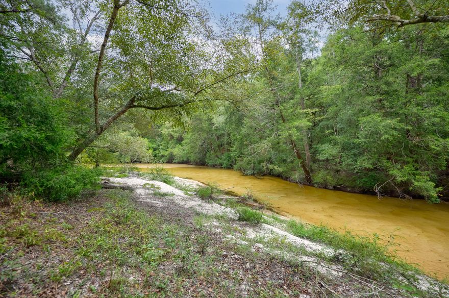 Seller has an assumable VA loan of 2.4% interest to qualified applicants.  Discover your own slice of tranquility at this 7 acre, 5 bedroom property in Crestview, a truly exceptional property located on a quiet cul-de-sac. This expansive estate offers the perfect blend of serene seclusion and convenient access to town. Embrace the peaceful surroundings with a stunning pond featuring pristine white sand frontage on Pond Creek, perfect for leisurely afternoons. The property is well-equipped with a versatile pole barn and RV hookups, catering to all your storage and recreational needs. Enjoy the inground swimming pool, ideal for relaxation and fun.

The home itself is a haven of comfort, featuring carpet throughout all five spacious bedrooms. The open flow between the dual living areas and the kitchen enhances the inviting atmosphere, making it perfect for both everyday living and entertaining. The primary bedroom offers a private en-suite bathroom for added privacy. A large Florida Room, complete with ceiling fans, overlooks the pool and provides a serene retreat.

Additional amenities include a reliable well water system and a septic system, ensuring convenience and efficiency for your daily needs. With its expansive acreage, scenic pond, and top-notch amenities, this property is a true recreational paradise. Don't miss out on the chance to own this unique gemschedule your showing today and experience the unparalleled lifestyle awaiting you at 6244 Turkey Track Street in Crestview.