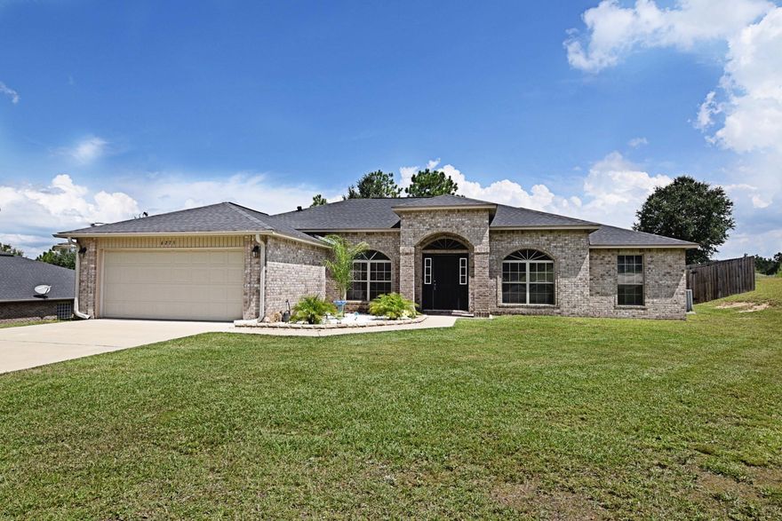 This MUST SEE stunning home has been meticulously maintained and is in MOVE IN condition! Better than new, it features many upgrades including GRANITE counter tops,STAINLESS appliances, HARDWOOD flooring,fully FENCED backyard,low maintenance BRICK exterior, and HUGE.64 lot, perfectly suited for a future pool! Do you need room to park your boat or RV? This home has room and a double gate to help get vehicles in.From the moment you enter, the high 10 foot ceilings add an open airy feel to this one story home. The kitchen is quite large and is perfect for a serious cook. Featuring elegant dark cabinets offset by light granite and a gorgeous back splash, it is perfect for entertaining and open to the large family room.The large island and breakfast bar add to the convenience for a busy family