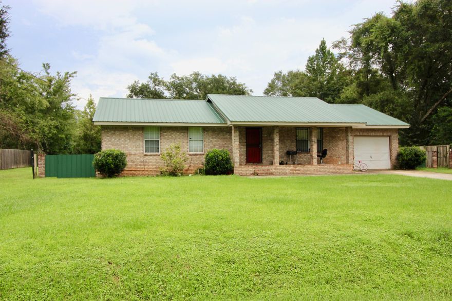 INVESTORS come see this large 3 bed 2 bath home with formal living room and huge den with cathedral ceilings. The home is currently rented month to month for $850.00 by tenants who have lived there three years. New metal roof and HVAC installed in 2014. Brick no maintenance exterior. Large covered front porch, one car attached garage all on over a half acre fenced yard. Home does need some TLC and is sold As Is.