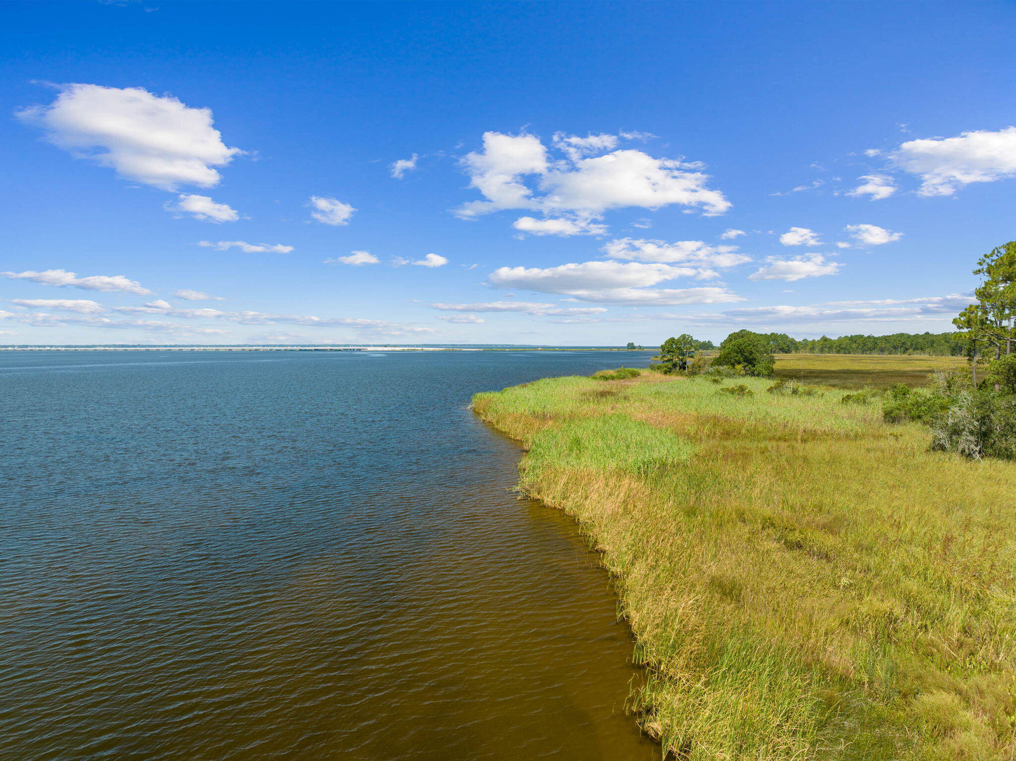 Discover a rare opportunity to own 17.86 acres off Jolly Bay Rd in Freeport, FL. This remarkable land offers stunning water views and limitless potential. Whether you envision a waterfront retreat, a custom sanctuary, or a high-end boutique subdivision with a possible marina, this property provides the ideal canvas. With deep water access to Choctawhatchee Bay in Walton County, famous for its white beaches along 30A, the possibilities are endless. Nestled in the sought-after area of Freeport, this land features breathtaking water views, perfect for a future home, family compound, mini farm, or small subdivision amid 100-year-old oak trees, magnolia trees, and palmetto palms, all contributing to its old Florida charm! Barn and pole barn on property. Showings by appointment only.