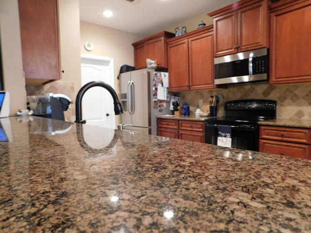 1.21 acres and a custom built, 4 bedroom home! Enjoy the peace and quiet with a small stream across your land. Outside there is an in ground sprinkler system, mani- bloc plumbing, a covered patio and room to run. Inside you will enjoy the textured ceilings with trays and crown molding. There are 4 bedrooms, a security system, formal dining room with a tray ceiling and chair railing & there is upgraded vinyl plank flooring. The kitchen is beautiful with Granite counter tops, tiled floors and back splash, soft close drawers and doors. The master bath offers double vanities, a soaking tub, a walk in shower and walk in closet. The sellers are even offering a one year home warranty for the extra piece of mind. Come by and take a look at this wonderful home on the edge of town and 1.21 acres!
