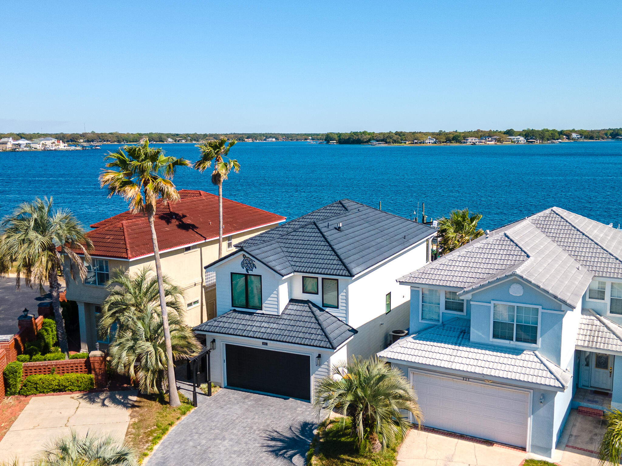 2 Boats can convey with acceptable offer! WATERFRONT home nestled behind the gates of Lighthouse Point Road, boasts 2 boat lifts and a jet ski lift, embodying the essence of coastal living. Featuring 3 bedrooms and 2.5 bathrooms, every aspect of this home has been meticulously crafted. Step inside to discover a fully renovated interior seamlessly connected to an expanded exterior Trex deck with outdoor grill and fireplace. Upstairs, the primary suite awaits, offering a private sanctuary with sweeping water views. From the cozy fireplace to the luxurious soaking tub and spacious open shower, every detail contributes to a retreat-like ambiance. Step outside to indulge in boating and jet skiing adventures right from your backyard, or simply unwind on the dock while taking in the mesmerizing views of the Bayou with the Gulf of Mexico and Destin's famed Crab
Island just minutes away, there's endless opportunity for recreation. Nestled amidst numerous area amenities, Lighthouse Pointe alsooffers convenient access to both Eglin and Hurlburt Air Force bases.