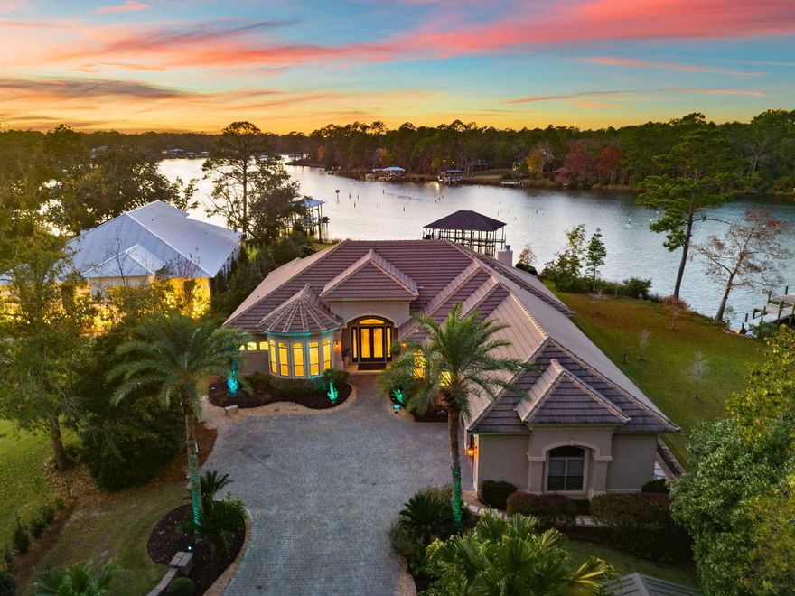 Welcome home to this stunning Mediterranean custom-built residence, perfectly situated on Deep Water Mallet Bayou. Set on over an acre of beautifully landscaped grounds with uplighting throughout, this home offers a unique blend of elegance and functionality. As you arrive, a winding paver stone driveway invites you into a serene oasis. Step outside to discover a luxurious Gunite saltwater pool, complete with a cascading waterfall and LED lighting, all within a screened enclosure supported by stylish stucco columns. The oversized covered lanai features an outdoor kitchen equipped with a Blaze built-in grill, a mini fridge, granite countertops, custom cabinetry, and a stainless steel sink, making it perfect for entertaining guests. The property boasts two covered boat docks with lifts, ... a separate power source at the dock's end, and a convenient fish cleaning station with a granite countertop. The meticulously designed backyard features custom tiered stone landscape walls and low voltage lighting, providing both privacy and stunning views of the picturesque bayou. Inside, the home impresses with a custom gourmet kitchen that includes a spacious island, high-end stainless-steel appliances, and ample granite countertops. Panoramic windows throughout the living room, kitchen, dining areas, and master bedroom showcase breathtaking views of the pool and bayou, allowing natural light to flood the space. The living room features a built-in wall unit and a cozy wood-burning fireplace, complete with a gas lighter for convenience. Architectural details such as custom crown molding, arched doorways, and tailored valances add a touch of sophistication throughout the home. The expansive master suite offers tranquil views and includes two walk-in closets with custom cabinetry. The luxurious master bath features granite vanities, tile flooring, a whirlpool tub, and a separate updated walk-in shower, creating a perfect retreat. Additional highlights of this exquisite home include a split floor plan, a separate oversized laundry room, with ceiling heights ranging from 10 to 12 feet, the entire home exudes a sense of spaciousness and elegance. The garage with epoxy floors, custom cabinetry and above attic storage with a separate staircase for easy access. Conveniently located near the beautiful Florida Gulf Coast beaches, shopping, dining, and entertainment, this Mediterranean residence is not just a homeit's a lifestyle waiting to be embraced!