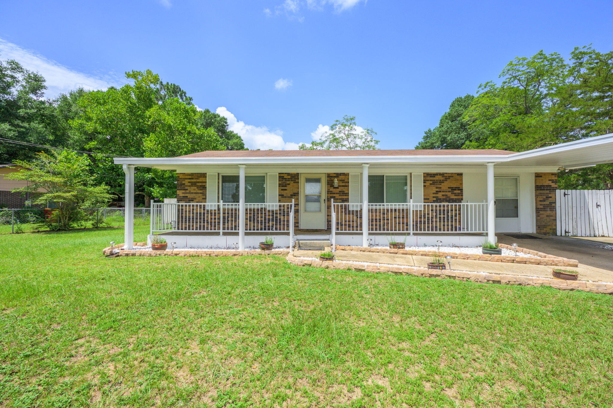 Welcome to this classic brick home nestled on an oversized lot, offering charm, functionality, and endless possibilities. A welcoming covered front porch invites you in while the screened back porch--recently updated and rescreened--provides a peaceful retreat. Inside, the versatile floorplan features well-separated bedrooms for added privacy and a spacious utility room that conveniently connects to the back porch. Enjoy peace of mind with recent upgrades, including brand-new windows and a new HVAC unit for year-round comfort. Additional features include a covered carport and two yard buildings--perfect for storage, hobbies, or a workshop. Located just a 5-minute drive from Publix, Winn-Dixie, shopping, and dining. Don't miss your chance to make this well-maintained property your own!
