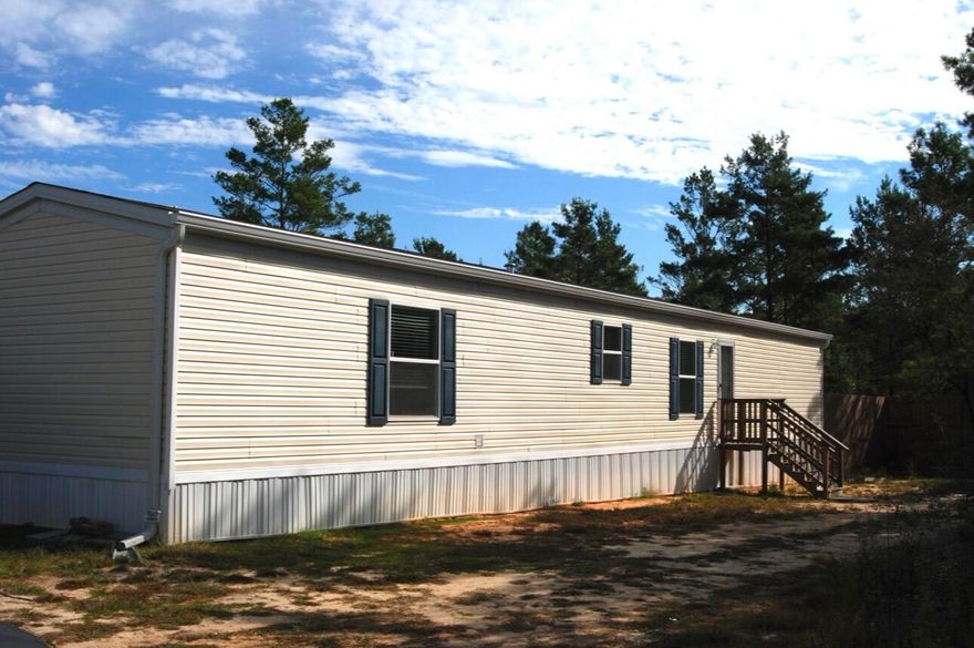 Welcome to this charming manufactured home on a spacious 0.22-acre lot with plenty of room to stretch out and relax. Featuring 3 bedrooms, 2 bathrooms, and a bright, open layout, this home offers comfort and functionality. Step outside and enjoy the large backyard, perfect for pets, gardening, or entertaining. The 8-foot privacy fence not only adds security but also ensures peace and quiet -- because as they say, good fences make great neighbors! Whether you're looking for your first home or an investment opportunity, this property is move-in ready and waiting for its next owner.