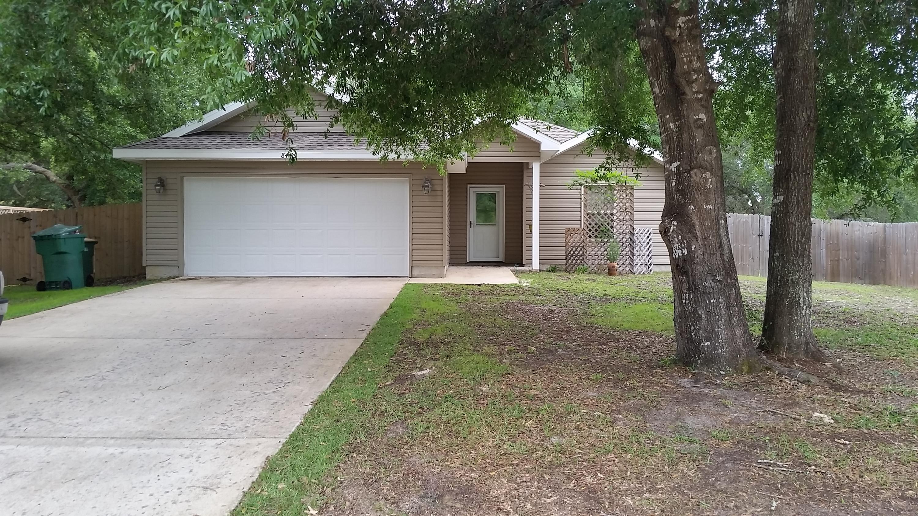 Great floor plan located in the heart of Navarre and short drive to beautiful beach on the Gulf Of Mexico. Convenient to Whiting Field, Hurlburt Field and I-10 access. Home is on nice lot in private and peaceful setting with pretty trees. Large living/dining area has 9' ceiling with recessed lighting and opens to kitchen. Fantastic kitchen with plentiful cabinets and work space boasts granite counters, stainless appliances, pendant lighting and vaulted ceiling. Knockdown ceilings throughout with trey ceiling in master bedroom and formal dining/den. French doors lead from formal dining/den to covered patio and nice size rear yard. Tile flooring in kitchen, inside laundry, formal dining/den, baths and entry. Master bath has dual vanity, garden tub separate toilet room and 2 walk-in closets.
