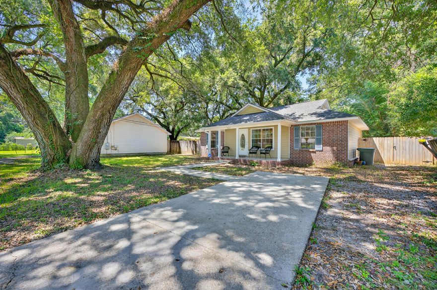 Welcome to this adorable Pensacola home, conveniently located just off N Palafox! With NO HOA and plenty of driveway space, there's ample room for your boat, RV, or multiple vehicles. The property is set on a lot filled with mature live oaks, offering shade, beauty, and a peaceful setting. A covered front patio adds to the curb appeal and provides a charming spot to enjoy your morning coffee. Step inside to find a comfortable layout designed for everyday living. The home features new carpet in 2 of 3 bedrooms and offers two spacious living areas, giving you flexibility for entertaining, relaxing, or creating a home office. The kitchen, dining, and living room flow seamlessly together, making the heart of the home open and inviting. The kitchen is complete with a pantry, plenty of cabinet  space, and a breakfast bar for additional seating.  Just off the kitchen, the utility room provides even more convenience with an additional storage closet, direct access to the backyard, and a built-in doggy door for your pets. The primary suite is tucked away in its own hallway for added privacy and features an en suite bathroom with a tub/shower combo. On the opposite side of the home, you'll find two additional bedrooms. One is equipped with a walk-in closet. A full bathroom is situated between them, also with a tub/shower combo. Outside, enjoy a spacious backyard complete with a covered patio that's perfect for relaxing or entertaining, plus a storage shed for all your tools and outdoor gear. Move-in ready and full of charm, this home offers a wonderful blend of comfort and functionality in a desirable Pensacola location!