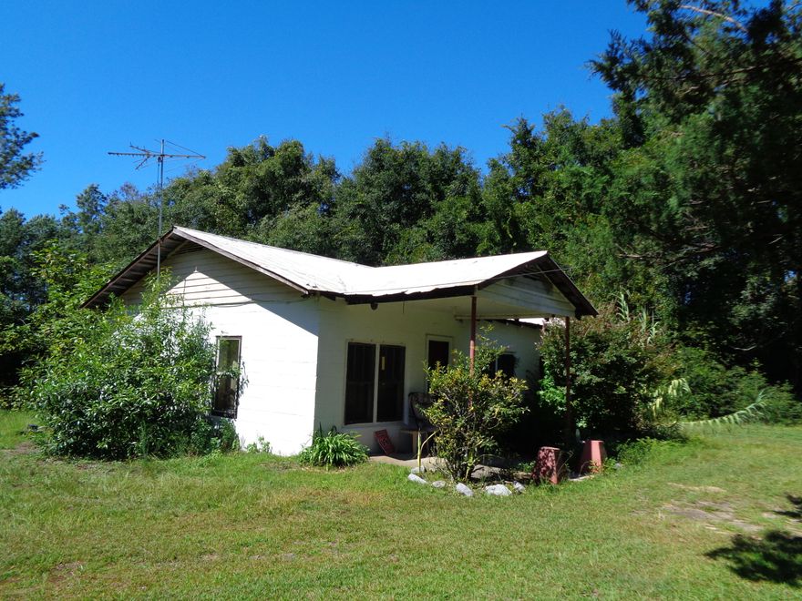 Older concrete block home on Rock Hill Rd just West of Red Bay. Easy location to the river or to the beach for a weekend spot. Property is being sold As-Is and does need work. The approximate 2 acres is mostly wooded. Well that services home is a shallow well. Washer hookup is in utility room. There is a small single carport in the back of the home. Older metal shed also included. Some fencing in the back yard. This is a cash sale only. Owner financing is not offered. Property cannot be rented.