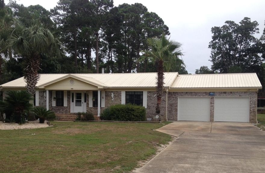 Large private lot (.831 acres) with Ranch Style brick home, small pool, attached 2 car garage and close to the beach. There is plenty of room to add on or add a guest house. The living room has vaulted ceilings, and a fireplace. The floor plan is a split bedroom plan with two bedroom and full bath on one side and the master bedroom, master bath on the other side.The kitchen has wood cabinets, electric Jennaire range, refrigerator and dishwasher which convey with home. The dining room has sliding glass doors that lead to the pool area and screened in porch. Exterior features include: metal roof, storage shed, nice landscaping and irrigation system. There are only two homes in the subdivision and three available lots to build on.