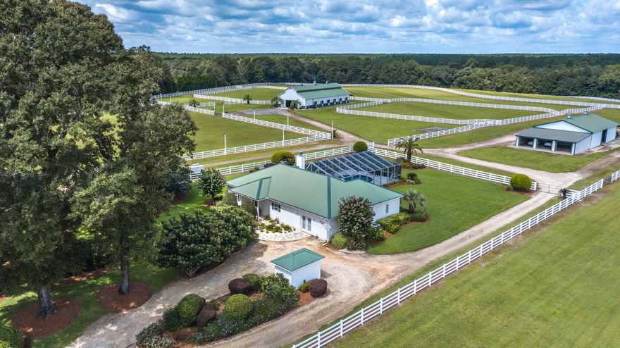 Unique opportunity to own a world class equestrian facility with versatility! Maxamillion Farms is capable of housing any riding style and has great income producing potential with infrastructure already in place to be used as a training, boarding or breeding facility. The beautiful home, barns, and wells offer all the support facilities needed for the operation. The Argentine Bahiagrass grazing land is fenced with 6 total paddocks, including two larger paddocks that you could turn up to 4 horses out into. The deeded lands consist of 41.8 acres, all of which can be classified as ag-exempt. There is plenty of opportunity for this beautiful property. Located in the Northwest Florida panhandle in the secluded outskirts of DeFuniak Springs, you would never know you are just 50 miles north of the beautiful Beaches of South Walton on Northwest Florida's Emerald Coast. Although, the farm is located in the rural north end of Walton County, the beach communities of the south end has driven booming growth; making Walton county one of the nation's fastest growing areas and driving infrastructure such as new schools for the county as a whole. Walton County is currently recognized as a Florida Department of Education A+ School district. 

DeFuniak has a humid subtropical climate which is characterized by high rainfall and mild winters that rarely go below freezing, resulting in a long growing season for agricultural and industrial crops. Maxamillion Farms is located just 20 miles from Interstate 10 and many of the region's A-rated equestrian events, including a short 4 ½ hour drive to the "Horse Capital" of Ocala.  You are also within 65 miles of two commercial airports; Destin-Fort Walton Beach Airport (40 miles); Northwest Florida Beaches International Airport (65 miles) in Panama City, or a short drive to DeFuniak Springs Municipal Airport.

Attention to detail and a whole lot of love went into the designing of this farm. It is fully fenced with beautiful high-performance electrified board fencing and equipped with everything you need for a world class equestrian operation!  Previously used as a hunter/jumper facility you will find a lighted outdoor riding arena with footing designed for performance horses. All paddocks and pastures have automatic water systems.  The farm is self-sustaining, equipped with an industrial size diesel generator that will supply power to the entire property.  There are multiple wells, including a high pressure agricultural well and three barns. 
The 4,800 sq. ft. modern horse barn can withstand winds up to 140 mph.  The barn is outfitted with custom rubber mats that aid in cleanliness and slip resistance and includes twelve, 14 x 14 stalls, each with their own center drain, individual high-performance ceiling fans and fly control system.  The air-conditioned tack room is equipped with washer/dryer, refrigerator and has hot & cold water and a ½ bath.  
The second barn is 4,840 sq. ft. and is currently being used as an equipment/storage barn and includes three over-sized car/truck garages with individual garage doors. The third barn is 6,850 sq. ft. with concrete flooring, great for storage for hay, shavings, and trailers but would also work well as a cattle barn.  

The residence is a 2,304 sq. ft., 3 bedroom, 3 bath, with two large living areas and a fully screened patio complete with pool and hot tub.  

This Equestrian Ranch is a dream; offering versatility for both a working and recreational lifestyle property with all the comfort and conveniences one could desire.