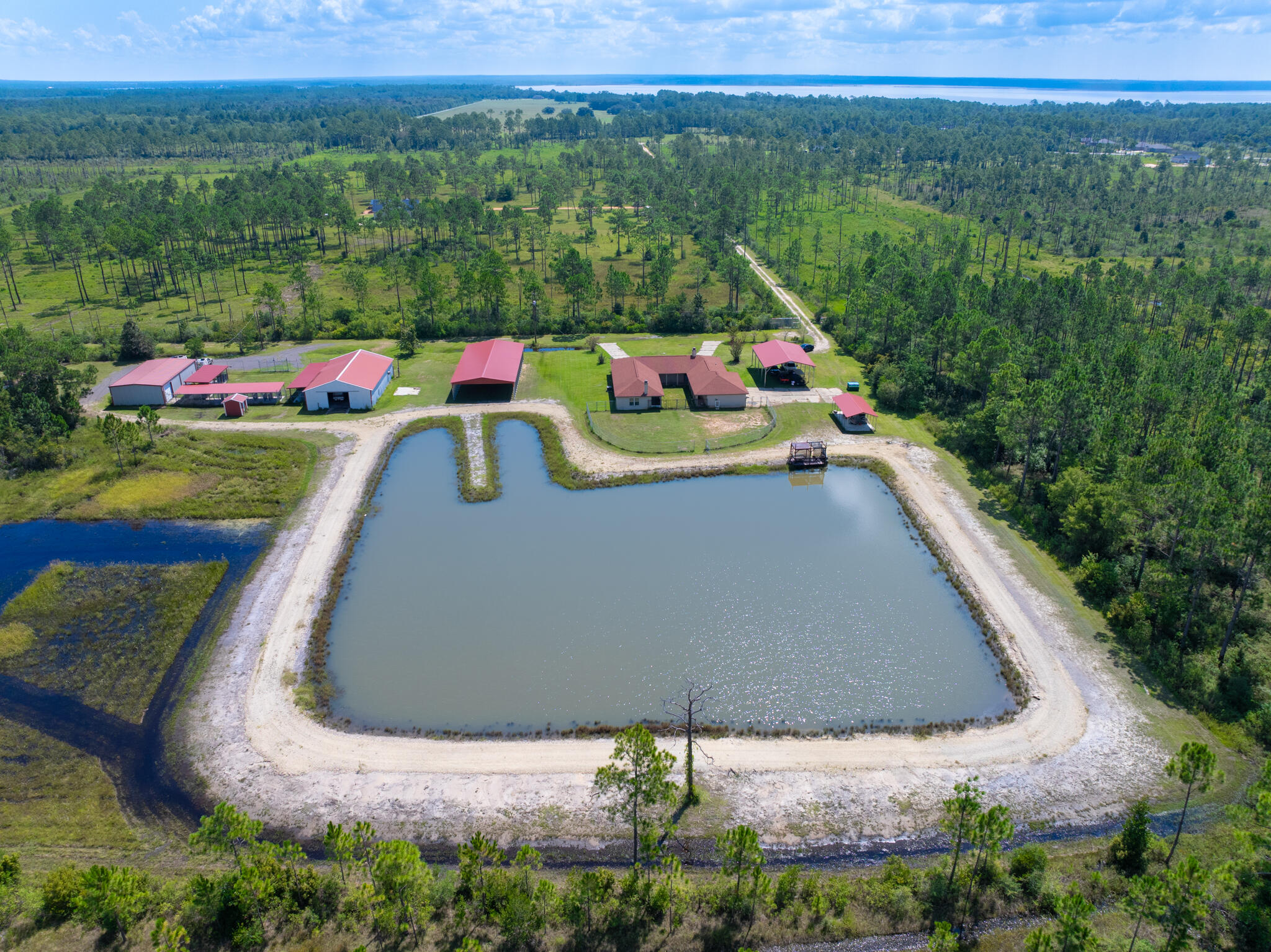 Your Dream Country Retreat Awaits: Perfect for Horse Enthusiasts, Dog Trainers, and Wildlife Lovers!If you're a horse lover, dog trainer, or passionate about wildlife, your search for a peaceful country haven ends here! Enjoy the best of both worlds with this beautiful *10 ACRE property located just 20 minutes from shopping and stunning beaches. Welcome to this 2,284 sq. ft. California Ranch-style home featuring 3 bedrooms and 3.5 bathrooms. As you enter, you'll be greeted by the rich allure of mahogany floors and wood beam vaulted ceilings. The cozy 2 sided wood-burning fireplace can be enjoyed from both the living room and the kitchen, creating a warm, inviting atmosphere for relaxation or gatherings.The kitchen features granite countertops, custom cherry cabinets, and Mexican Saltillo tile floors, creating a warm and inviting culinary space.
The spacious primary suite offers its own comforting wood-burning fireplace, a large custom closet and an en suite bathroom featuring a separate tub and shower with double vanity and tile flooring.
The two additional bedrooms each come with their own full bathrooms, ensuring privacy for family and guests.
Step outside to enjoy the one-acre pond, perfect for leisurely strolls or simply soaking in breathtaking sunsets.
This property is equipped with a private well with a water filtration system and 2 septic tanks, helping maintain lower utility bills.
You'll also appreciate the three-car garage and ample outdoor parking/storage. The property features 3 metal carports , one being 30x60 with 14-foot ceilings - perfect for RV parking. A 30'x50' barn that can be converted back to its original equestrian use.
Impressive 40'x60' insulated metal building with roll down door and 1/2 bath offering versatile options for your hobbies or business needs. Both barn and the large metal shop are equipped with separate utility poles.
With so much to offer, this country retreat perfectly balances spacious living and outdoor enjoyment, all while being zoned for agriculture. This means you can pursue your passion for farming or equestrian activities right from your doorstep. Don't miss the opportunity to make this tranquil haven your forever home!