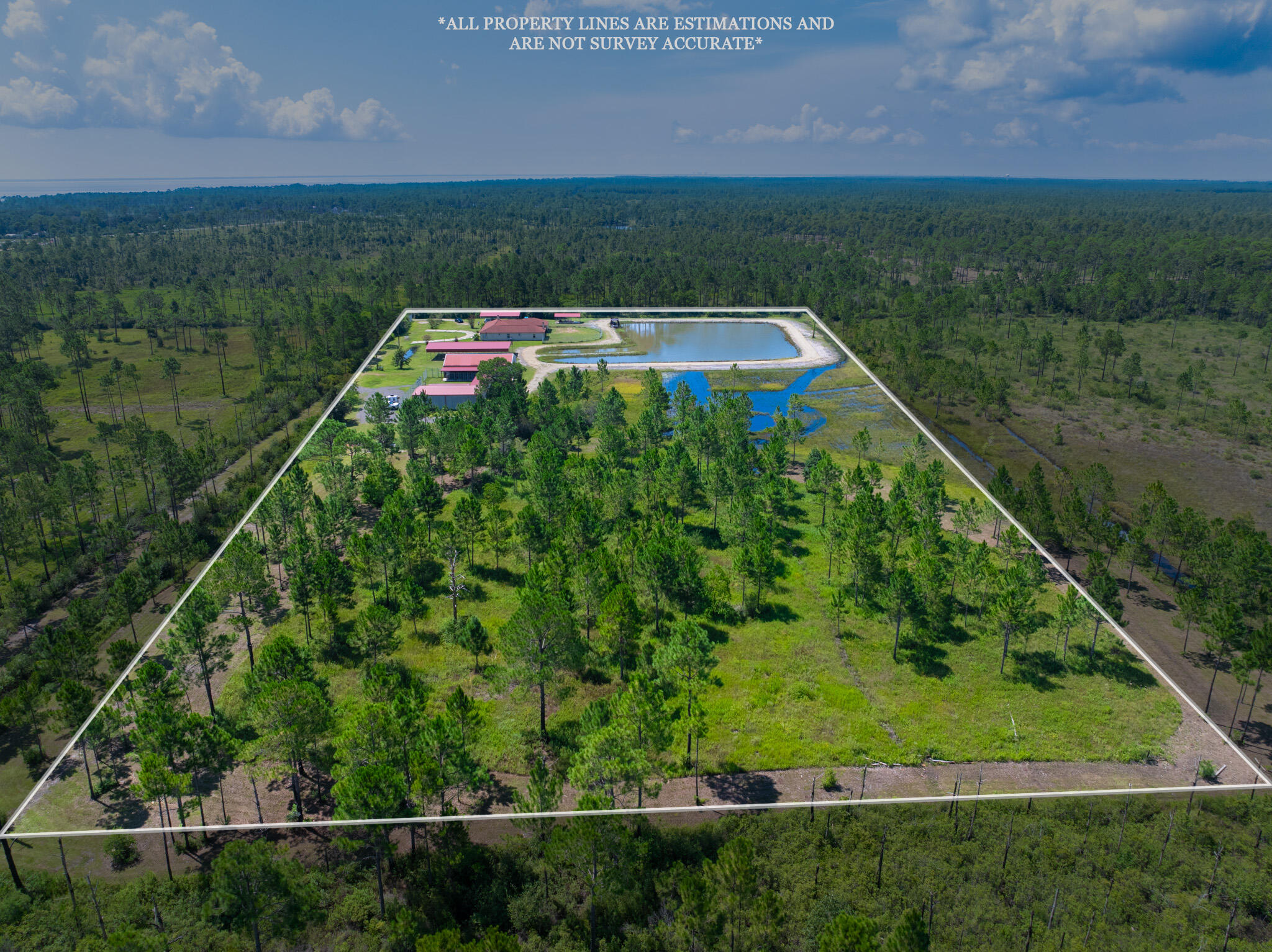 NEW ROOF to be installed prior to closing. Sale includes 40K worth of kennels. If you're a horse lover, dog trainer, or passionate about wildlife, your search for a peaceful country haven ends here! Enjoy the best of both worlds with this beautiful 9.996 acre property located just 20 minutes from shopping and stunning beaches. Welcome to this 2,284 sq. ft. home featuring 3 bedrooms and 3.5 bathrooms. ALL BEDROOMS EQUIPPED WITH PRIVATE FULL BATHROOM. The cozy 2 sided wood-burning fireplace can be enjoyed from both the living room and the kitchen. Spacious primary suite offers its own wood-burning fireplace, a large custom closet and an en suite bathroom featuring a separate tub and shower with double vanity and tile flooring.
Step outside to enjoy the one-acre pond, perfect for leisurely strolls or simply soaking in breathtaking sunsets.
This property is equipped with a private well with a water filtration system and 2 septic tanks, helping maintain lower utility bills.
You'll also appreciate the three-car garage and ample outdoor parking/storage.
The property features 3 metal carports , one being 30x60 with 14-foot ceilings - perfect for RV parking. A 30'x50' barn that can be converted back to its original equestrian use.
Impressive 40'x60' insulated metal building with roll down door and 1/2 bath offering versatile options for your hobbies or business needs. Both barn and the large metal shop are equipped with separate utility poles.
With so much to offer, this country retreat perfectly balances spacious living and outdoor enjoyment, all while being zoned for agriculture. This means you can pursue your passion for farming or equestrian activities right from your doorstep. Don't miss the opportunity to make this tranquil haven your forever home!