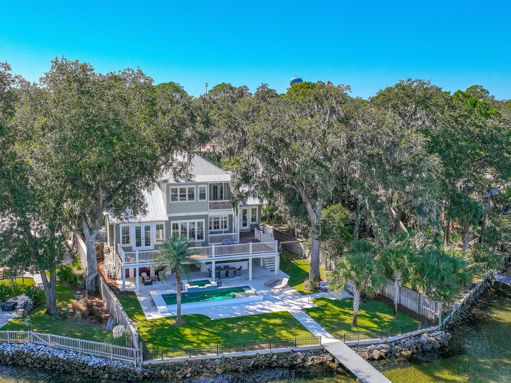This bayfront house is the essence of waterfront living with its coastal design breathtaking views. Inside, you'll find spacious living areas filled with natural light, a gourmet kitchen with top-of-the-line appliances, and an open floor plan perfect for entertaining. The house offers four generously sized bedrooms (all ensuite) each thoughtfully designed with comfort and relaxation in mind. Two master suites feature panoramic views of the bay and private balcony, offering a serene retreat at the end of the day. Stepping outside onto the large deck, residents are met with an outdoor oasis. The large entertaining area with saltwater pool and hot tub provides plenty of space for hosting gatherings with family and friends whether it's a barbecue by the pool or a sunset cocktail party overlooking the Choctawhatchee Bay. The highlight is the private dock, where you can relax and watch dolphins swim by, adding a magical touch to your coastal living experience.
For those who love spending time on the water, this property has a covered 10K lbs boat lift, allowing easy access to boating adventures right from the backyard.
With its perfect blend of indoor and outdoor living spaces, many amenities, and unparalleled waterfront location, this Bayfront house is a true coastal paradise, offering a lifestyle of luxury and relaxation for its fortunate residents.
Located just minutes from the vibrant dining and shopping scene of 30A, white sand beaches of Emerald Coast, this home offers the ultimate coastal lifestyle. Don't miss your chance to own a piece of paradise in Santa Rosa Beach!