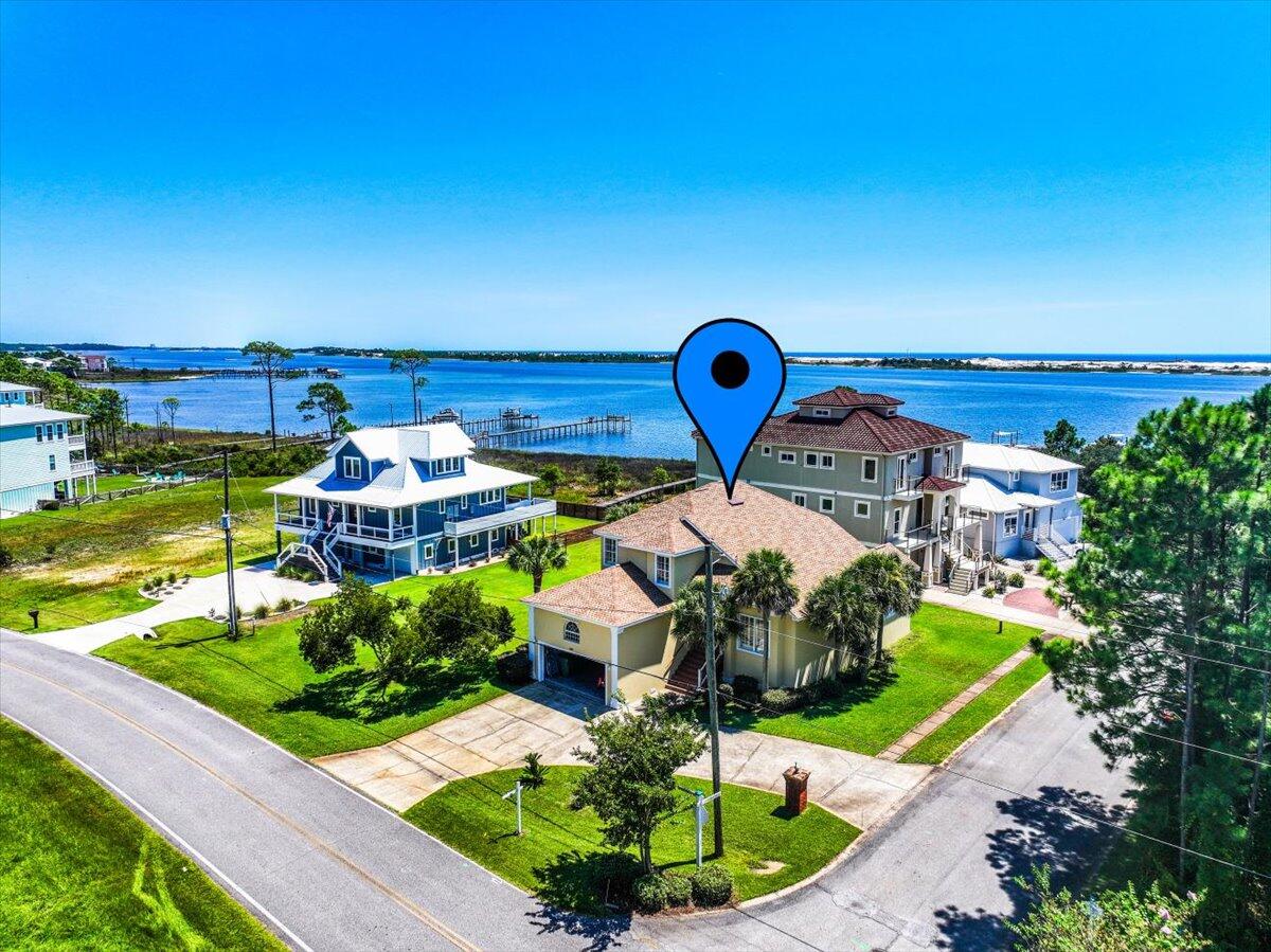 Water Views of the Santa Rosa Sound. Deeded BOAT SLIP with water and electric. Charming Private Community Beach and Dock in the highly sought after Sparkling Waters neighborhood. This exceptional 4/2.5 home is on a corner lot complete with Primary/Master Bedroom on the lower level, Custom Plantation Shutters throughout the home, Sunroom with large Deck to watch the sun come up over the Sound, Tile and Bamboo Wood Flooring upstairs, no carpet, Soaring Great Room Ceiling, and Centex Builder Center Block Construction for powerful strength. The Kitchen has a Bar Counter Top, Breakfast Area and Formal Dinning Room perfect for relaxation or entertaining. View the walk through video and you will fall in love.
