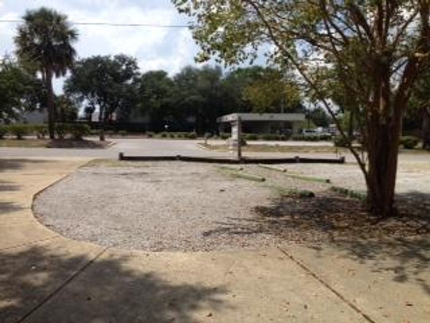 Great Commercial lot in the middle of Fort Walton. This would be great for a Dentist or Doctors office, flower shop, architect or builders office. The list goes on. Where can you find a lot that backs up to a 6.99 acre green built. You have a park in your back yard. The driveway and parking is already in. The horse shoe driveway is shared with the hair salon next door. They have a tenancy in common between the two lots. Water and sewer taps have been paid for. At one time the sellers considered building. At that time they where able to get 10ft variance from the park. You are 1 Block off of Eglin. Directly behind the bank. Location, Location