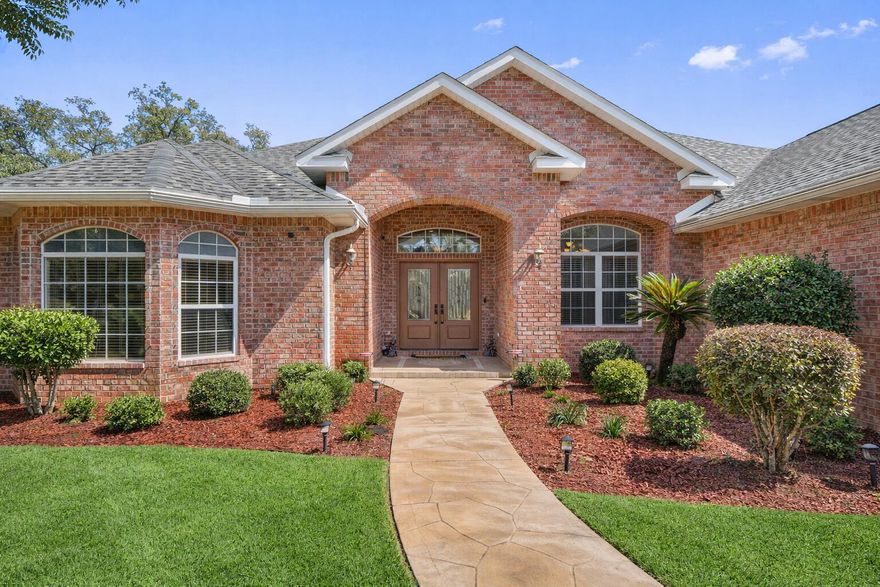 Exceptional golf course living with panoramic views of the 16th hole in Hidden Creek Estates. This 4BR, 2.5BA home offers 3,211 sq ft of open, light-filled space with soaring ceilings, recessed lighting, and a fireplace in the great room. Chef's kitchen features 42' cabinetry, wall ovens, cooktop with pot filler, tiled backsplash, and ample prep space. Washer and dryer convey in oversized laundry room. Covered lanai and extended paver patio overlook the fairway. Backyard includes peach, pear, orange, grapefruit, blueberry, and raspberry trees. .43-acre lot, oversized 2-car garage, new 2024 roof, lien-free solar panels. Community pool, playground, tennis courts.