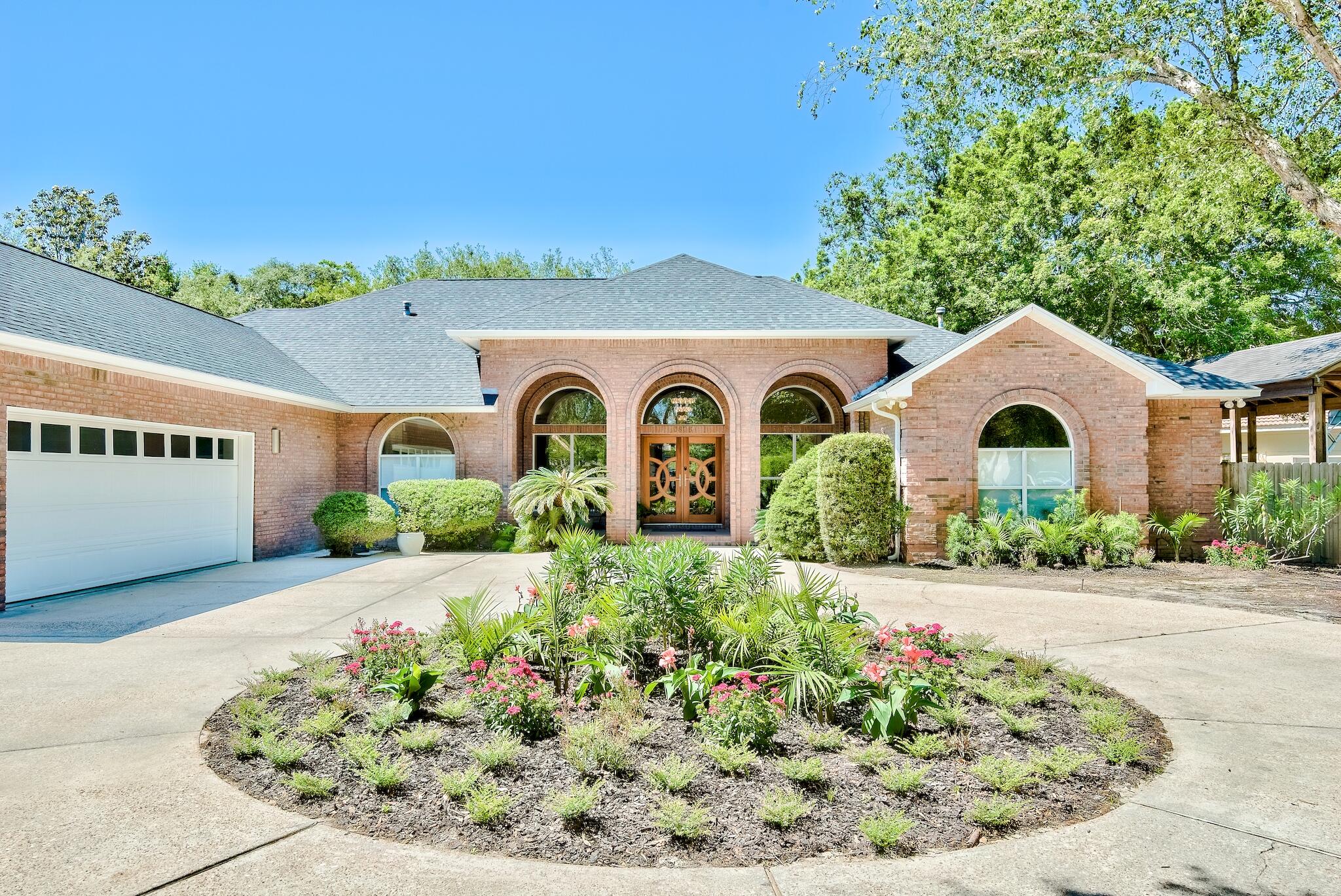 Modern oasis in the heart of Destin won't last long. This beautiful and completely updated home is located on the coveted street of Indian Tr. with over 3,000 sf of living space and a fenced yard, this contemporary style house provides ample privacy outside and a spacious Florida room to enjoy the sunshine all year. There is a circular driveway leading to a grand entrance with floor to ceiling windows, French doors and dining columns. Inside there is a spacious open concept foyer with formal living and dining space. Continue towards the back of the home to find the stunning and renovated kitchen that features tray ceilings, stainless steel appliances, and custom cabinetry with a high gloss, metallic lacquer finish.