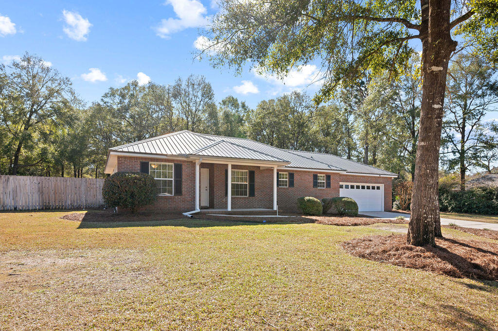 Escape to the tranquility of this beautiful Key Lime built home situated on a lush 1-acre lot, in the sought after Hidden Springs subdivision. You will absolutely love the country setting of this home and all that it has to offer!!! Boasting a thoughtfully designed layout with brand new luxury vinyl plank flooring throughout the main living areas and bedrooms, and tile in bathrooms and laundry room. NO CARPET! This home blends functionality and charm and truly offers everything you need and more. Trust me when I say that you will feel at home the moment you enter this lovely home. Featuring a spacious and airy floor plan filled with natural light, making it ideal for both relaxing and entertaining. Master is located on one side with the additional bedrooms and full bath on the other. Spacious dining room and family room located off of the kitchen with a cozy corner fireplace. Kitchen with newer appliances and breakfast bar. There are so many thoughtful touches throughout the home that add to its warmth and character while showing definite pride of ownership at the same time. The amount of storage is very impressive! There are extra closets galore, both inside the home and in the garage. The garage is well thought out and EXCEPTIONAL by the way! French doors off of the family room lead to an outside patio that stretches across the back of home overlooking your absolutely breathtaking backyard! With a sunsetter awning installed, this will be your true outdoor oasis. The expansive yard provides plenty of space for outdoor activities, gardening, or simply enjoying the peace and quiet of rural living. If you love yardwork you will certainly love the outdoor shower in place for your convenience as well. Last but certainly not least is a versatile yard building complete with electricity that would be perfect for a workshop, studio or just extra storage. This home has been meticulously maintained and is an absolute must-see! Come and experience the lifestyle you've been dreaming of! Significant items: Metal roof 2014, HVAC 2020, Water Heater 2018 and termite bond in place with Florida Pest Control.