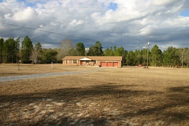 Just over 8 acres of country living awaits you in this charming north Crestview home! The kitchen, dining room and living room are all open in one area, making for a great gathering place. There's a cozy corner fireplace in the dining area and the kitchen has been updated and features a huge center island with lots of storage. There's a nice ''butler's'' pantry to one side of the kitchen with more custom cabinets and room for a freezer. The bathrooms have also been updated and all major items have been replaced within the last 10 years or less. Those items include the roof, the A/C (a geothermal heat pump) hot water heater, plumbing, garage doors, windows and flooring. Most of the house has a high quality vinyl flooring that looks just like hardwood. It's durable and looks great. There