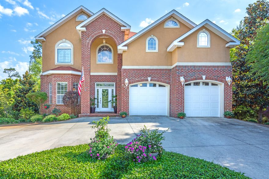 Coastal elegance; a truly custom home perched atop a one half acre parcel teeming with charm. Thronged with pencil pines and crepe myrtle which lend their leaves and aid in the breaking up of the expansive blue waterfront. As golden rays of light pass through, the gentle chatter of the water's edge can be heard along your private beachfront, complemented by a 500 ft dock and boardwalk- paddle board ready and equipped with 5,000 lbs boat lift. This is the essential and inherent trait which most aptly describes such a place: serenity. Laden with upgraded features, you'll find common areas adorned with Italian Travertine, Swarovski crystal chandeliers, hardwood Thomasville cabinetry with ''soft close'', marble or granite surfaces throughout, two Jacuzzi tubs, 2 newer A/C units, & warranty.