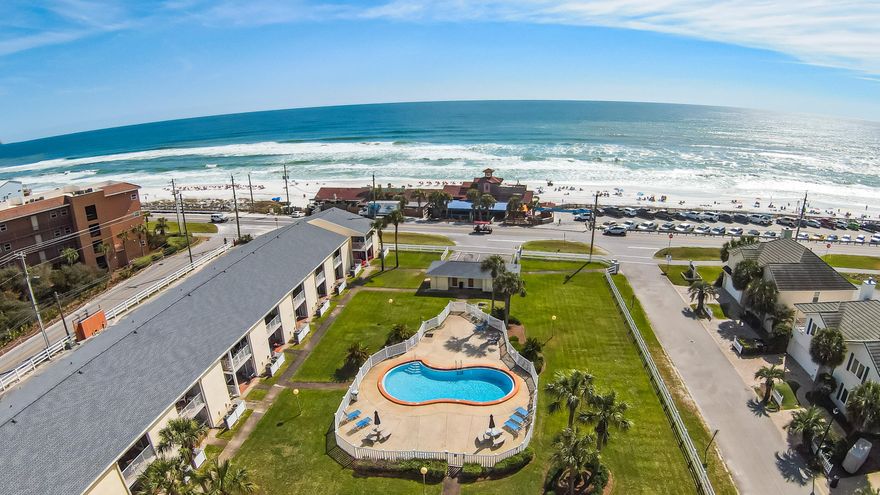 Welcome to your coastal retreat! Enjoy UNOBSTRUCTED picturesque views of the Gulf of Mexico!  Prime location directly across the street from the sandy white beach and Pompano Joe's. Unwind on your private covered balcony, accessible from both the bedroom and living room, where panoramic vistas of the Gulf waters and beach and the sparkling pool await. Imagine sipping your morning coffee or enjoying evening cocktails against this breathtaking sunset from your private balcony. Embrace the coastal lifestyle with easy strolls to nearby ice cream shops, coffee houses, restaurants, and souvenir boutiques. This stunning 1-bedroom unit with a bonus bunkroom offers more than just a home; it's a lifestyle upgrade. Step inside to discover an impeccably remodeled space that sleeps up to 6 people.